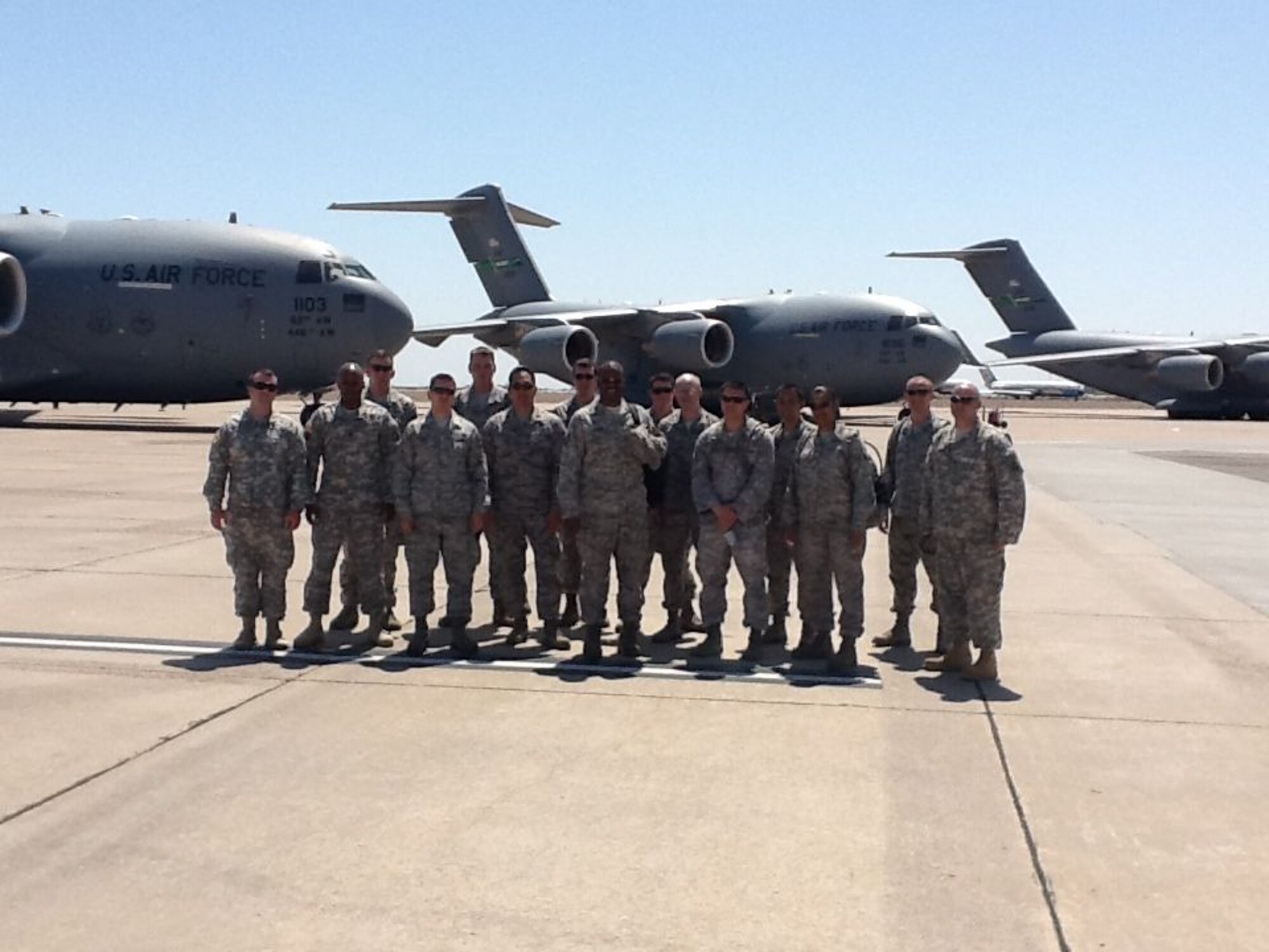 U.S. Air Force aerial transportation specialists and U.S. Army Cargo Handlers gather for a group photo at Phoenix-Mesa Gateway Airport, Ariz., April 23. Soldiers from the 688th Rapid Port Opening Element based at Joint Base Langley-Eustis, Va. and Airmen assigned to the 818th Contingency Response Group from Joint Base McGuire-Dix-Lakehurst, N.J., worked jointly to asess three airfields in the Greater-Phoenix, Ariz. area April 18 to 24. (U.S. Army photo by 1st Lt. Edward McCann)
