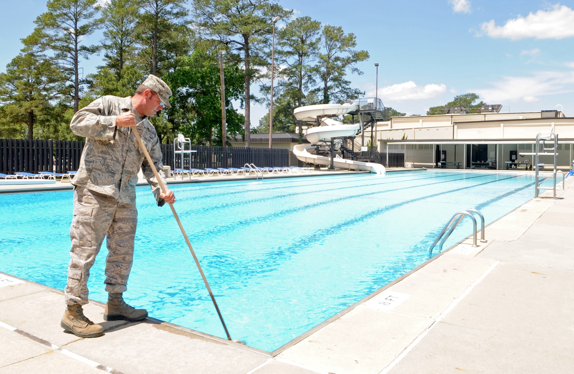 U.S. Air Force Tech. Sgt. Lucas Pendleton cleans a pool drain in preparation for the opening of the Olympic pool on Seymour Johnson Air Force Base, N.C., May 10, 2012. The Olympic pool officially opens June 7 and patrons can swim daily for $3 from 1-6 p.m. Pendleton, 4th Civil Engineer Squadron water and fuels systems maintenance craftsman, hails from Ithaca, N.Y. (U.S. Air Force photo/Airman 1st Class Aubrey Robinson/Released)