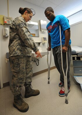 U.S. Air Force Staff Sgt. Bridget Williams instructs Airman Mario Poe on how to properly walk with crutches at the 4th Medical Group on Seymour Johnson Air Force Base, N.C., May 8, 2012. Patients with an injury that limits their walking ability use crutches as a mobility assistant. Williams, 4th Medical Operations Squadron medical technician, is from Little Falls, Minn. Poe, 335th Aircraft Maintenance Unit avionics technician, hails from Memphis, Tenn. (U.S. Air Force photo/Airman 1st Class John Nieves Camacho/Released)