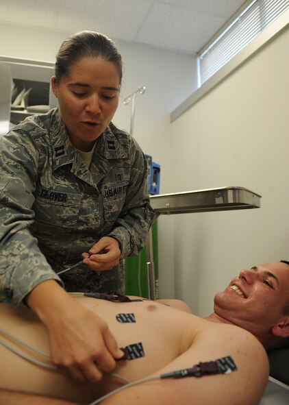U.S. Air Force Capt. Julie Glover attaches leads to Staff Sgt. David Frederick in preparation for an electrocardiogram test at the 4th Medical Group on Seymour Johnson Air Force Base, N.C., May 8, 2012. Glover uses the ECG to search for diseases, monitor medicine effects and reveal abnormal rhythms of the heart. Glover, 4th Medical Operations Squadron physician’s assistant, is from Whitehall, Pa. Frederick, 4th Medical Operations Squadron medical technician, is a native of Lake Charles, La. (U.S. Air Force photo/Airman 1st Class John Nieves Camacho/Released)
