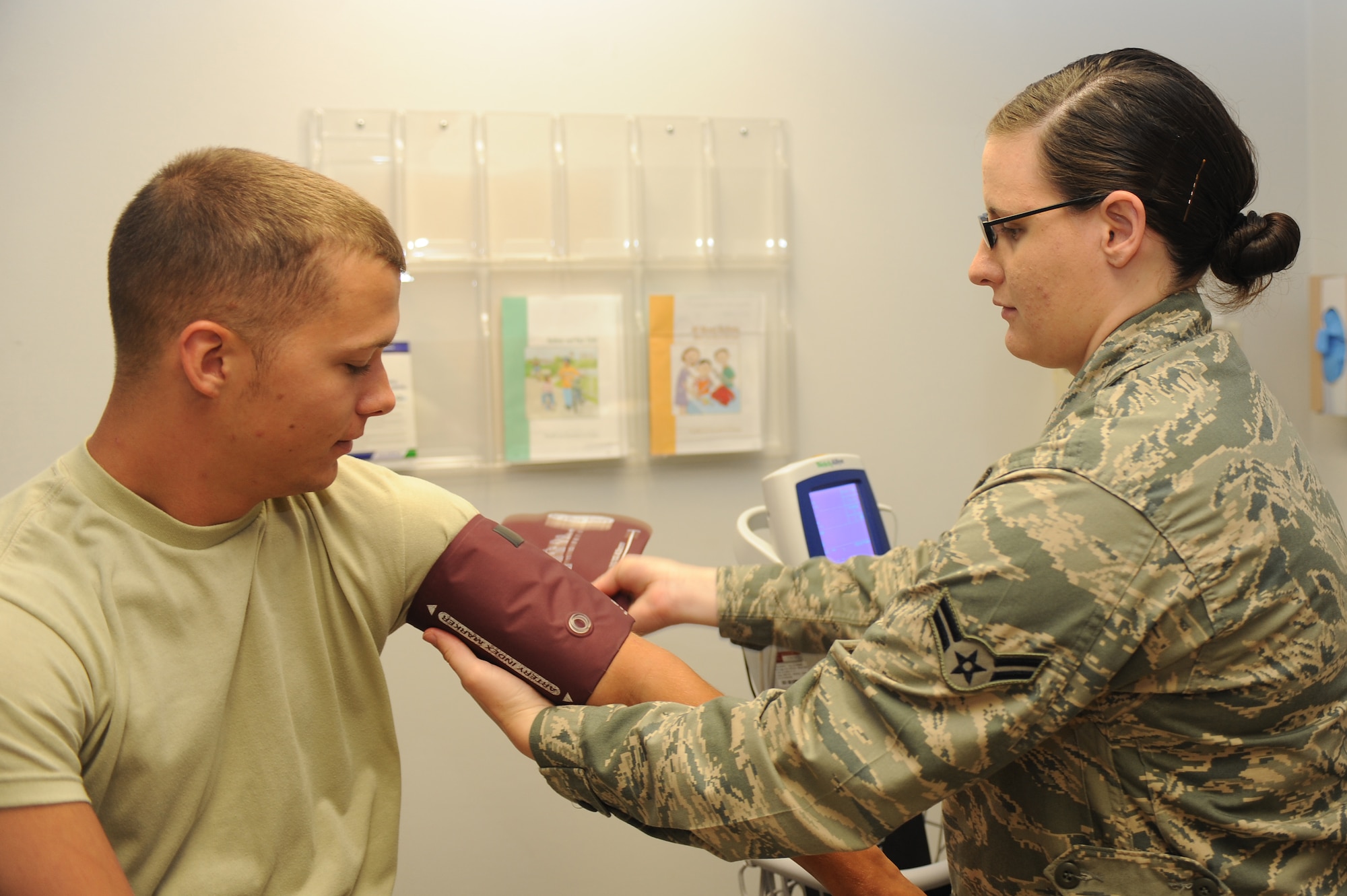 U.S. Air Force Airman 1st Class Kelsey Rayburn secures a blood pressure cuff to Senior Airman Christopher Cavin’s arm during sick call at the 4th Medical Group on Seymour Johnson Air Force Base, N.C., May 9, 2012. Prior to being seen by the physician it is mandatory for each patient to have their vital signs taken. Rayburn, 4th Medical Operations Squadron medical technician, is from Hagerstown, Ind. Cavins, 4th Contracting Squadron contract specialist, hails from South Rockwood, Mich. (U.S. Air Force photo/Airman 1st Class John Nieves Camacho/Released)