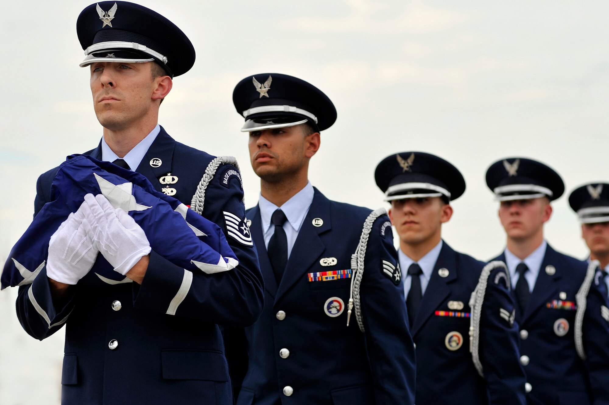Airmen assigned to the Shaw Air Force Base Honor Guard march in formation with a folded U.S flag at the close of a retreat ceremony May 4, 2012, at Shaw Air Force Base, S.C. The base honor guard conducted the retreat ceremony at the end of the first day of Shaw AFB’s Air Expo. (U.S. Air Force photo/Senior Airman Kenny Holston)