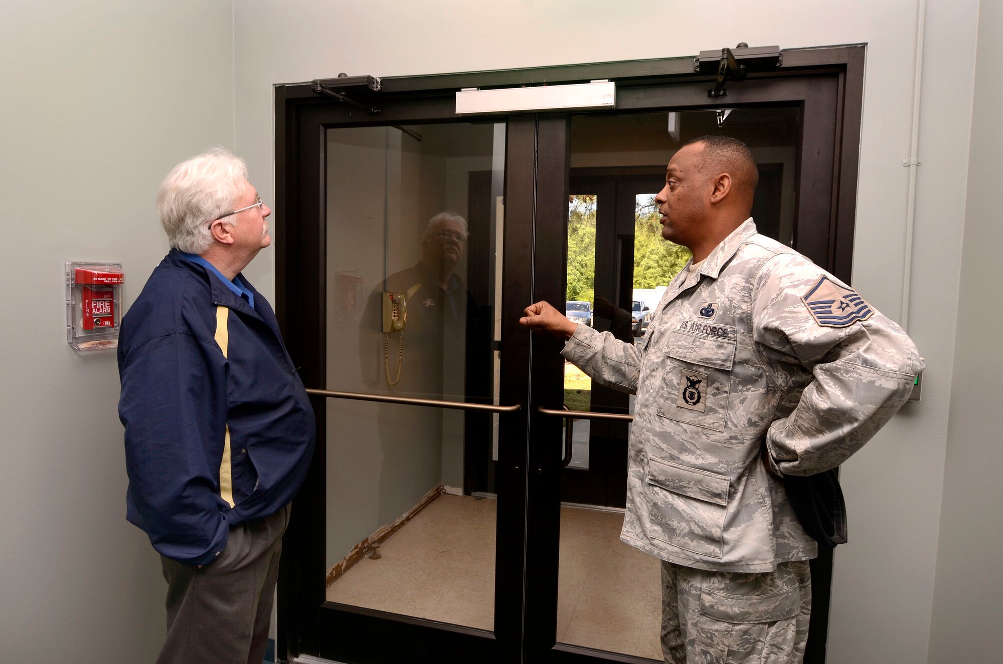 Hugh Phillips, 94th Civil Engineer Squadron and Master Sgt. Dennis Riggins, 94th Security Forces Squadron, discuss improvements made to the main entry of the Security Forces building at Dobbins Air Reserve Base, Apr. 12.  This is one of many projects in various stages of progress which the base civil engineers initiate and monitor through to a successful l completion.  (U.S. Air Force photo/ Brad Fallin)