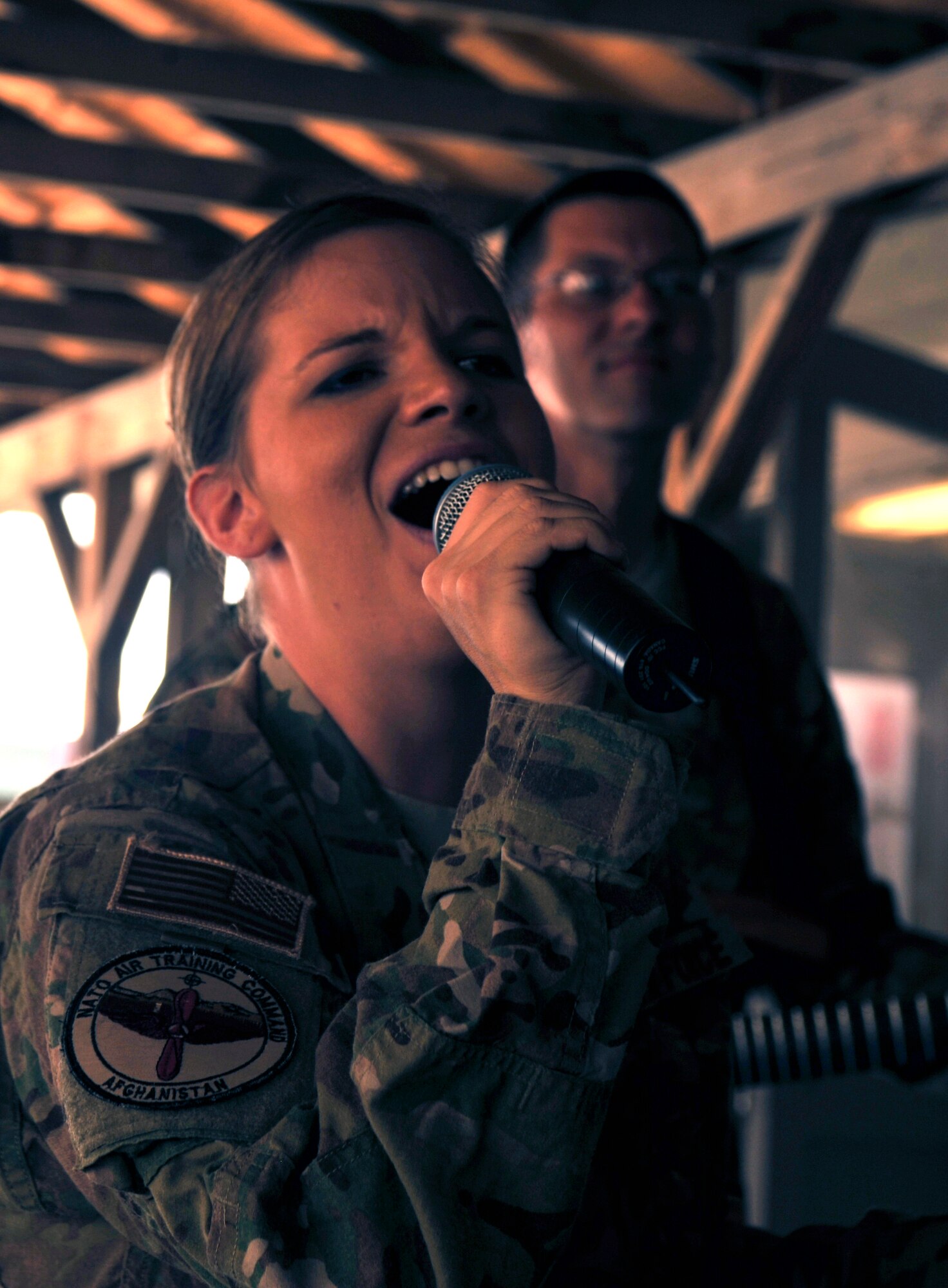 Airman 1st Class Melissa Rager sings a solo while performing with the Air Forces Central band Night Wing at Bagram Airfield, Afghanistan, May 9, 2012. Rager is the lead vocalist and has traveled to multiple locations throughout Southeast Asia to perform for deployed members. (U.S. Air Force photo/Airman 1st Class Ericka Engblom)