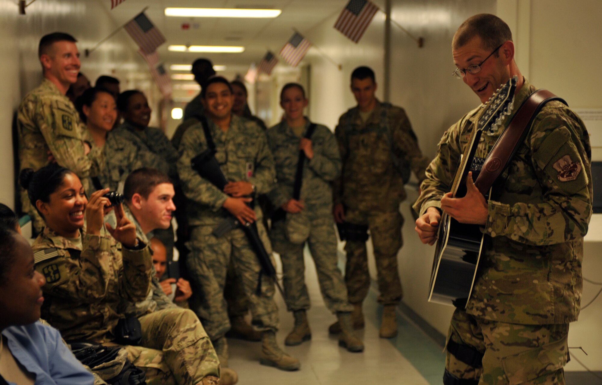 Airman 1st Class Lee Heerspink plays a guitar solo for Craig Joint Theater Hospital staff at Bagram Airfield, Afghanistan, May 9, 2012. Heerspink is a guitar player with the Air Forces Central band Night Wing. Night Wing performed for deployed troops in various locations throughout Southeast Asia. (U.S. Air Force photo/Airman 1st Class Ericka Engblom)