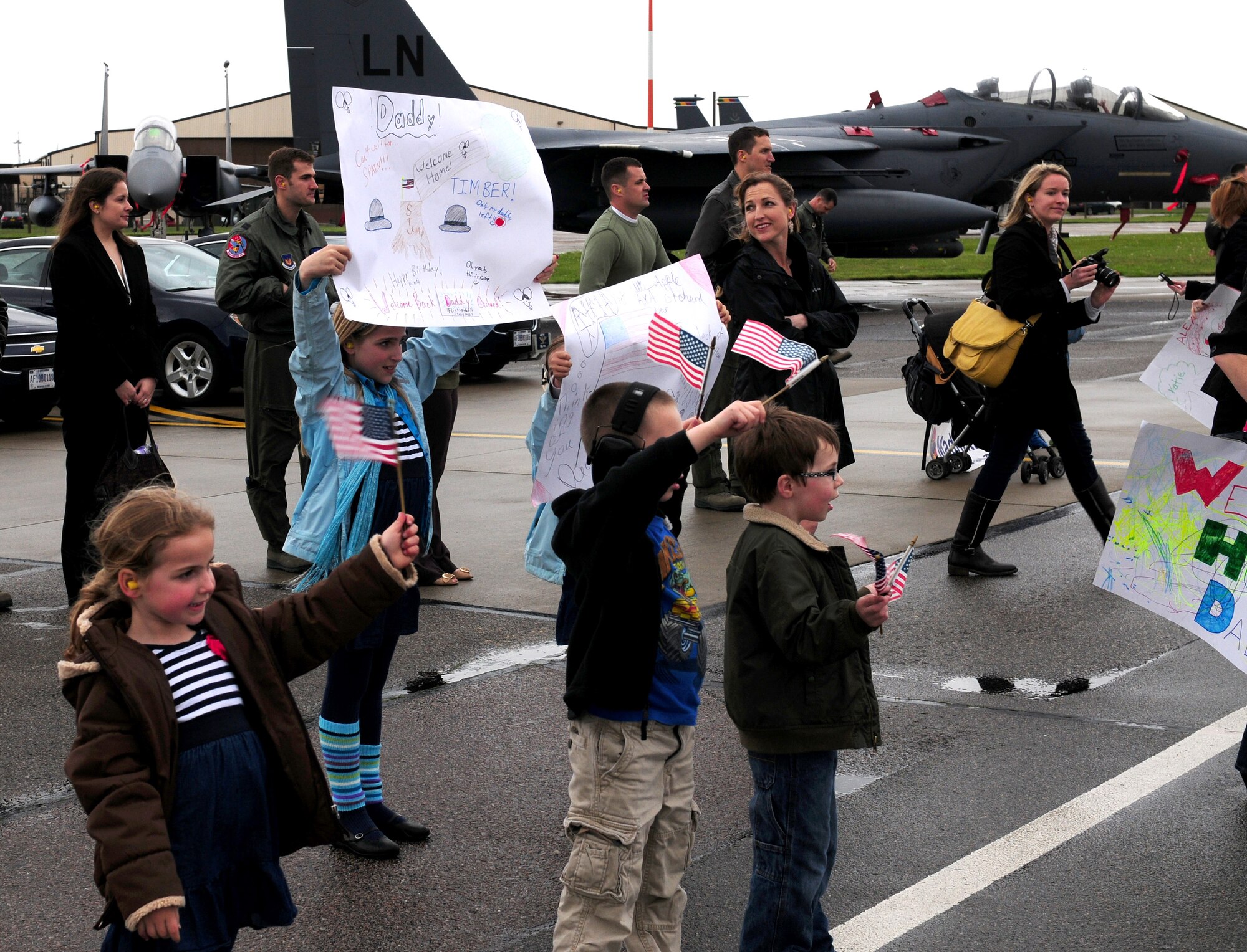 ROYAL AIR FORCE LAKENHEATH, England ? Family members eagerly anticipate the return of the 492nd Fighter Squadron, May 10, 2012.  The families, as well as other members from the 48th Fighter Wing, welcomed the squadron home after a six month deployment.  (U.S. Air Force Photo by 2nd Lt. Lyndsey Horn)