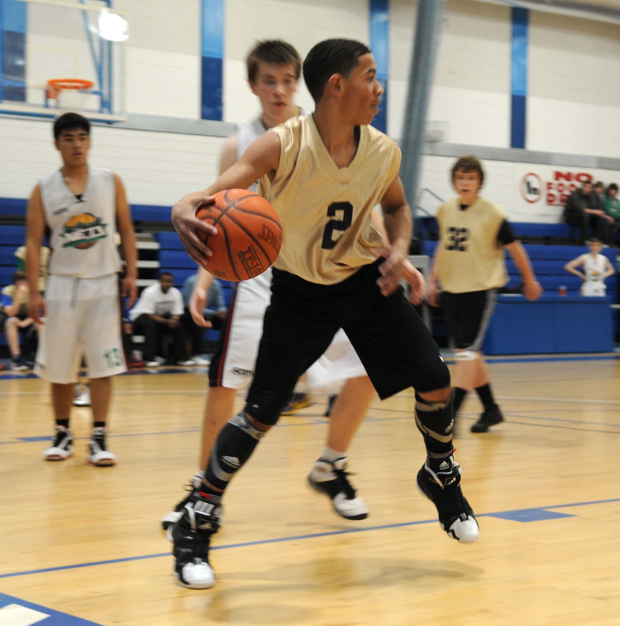 Eighth grader Isaiah Joyce, RAF Mildenhall and RAF Lakenheath combined youth seventh and eighth grade basketball team, looks for an open teammate to pass the basketball to during a game against a Lynn Nets basketball club’s under 16 team May 5, 2012, at the Lakenheath Fitness Center.  The American youth won the game 56 to 55. (U.S. Air Force photo/Staff Sgt. Christopher Waller)