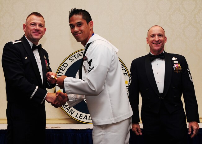 Col. Richard McComb, Joint Base Charleston commander,  and Chief Master Sgt. Earl Hannon, JB Charleston command chief, present a diploma to Petty Officer 2nd Bradley Nguyen, 628th Security Forces Squadron, during the Airman Leadership School Class graduation May 4 at JB Charleston - Air Base. (U.S. Air Force photo/Staff Sgt. Katie Gieratz) 