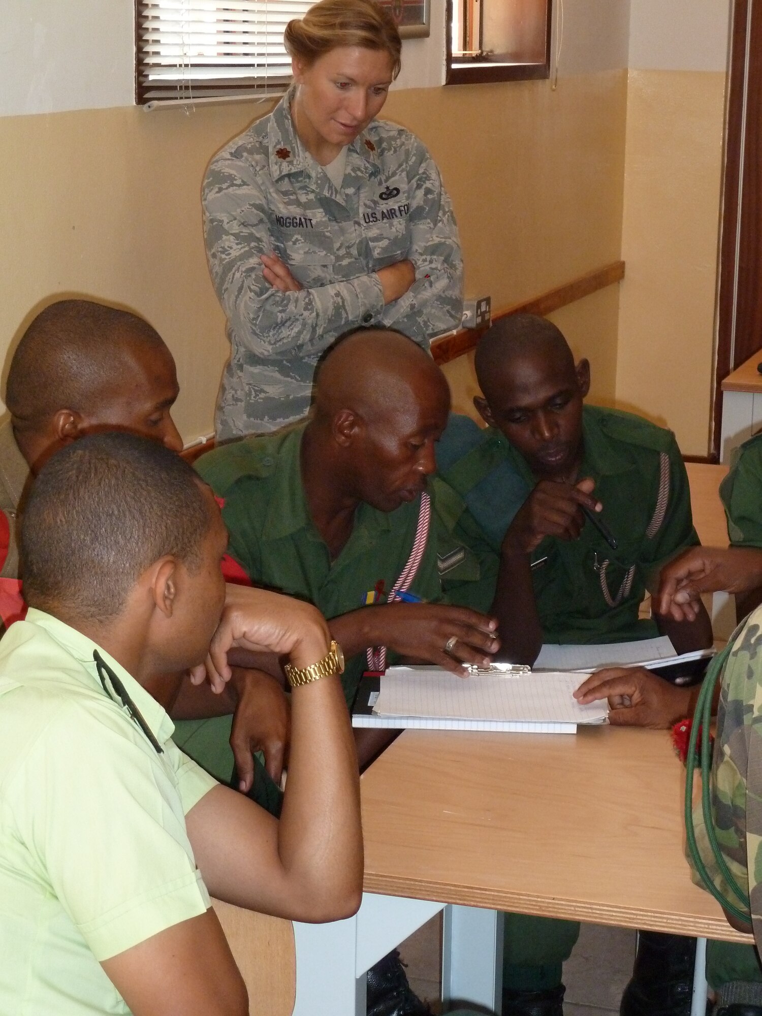 Maj. Christina Hoggatt, U.S. Air Forces Africa public affairs officer, observes several members of the Botswana Defense Force while they work through a public affairs training scenario May 8 in Gabarone, Botswana.  Hoggatt was part of a three-person public affairs team that conducted a week-long training course for the BDF as part of AFAFRICA’s ongoing commitment to building partnership capacities with their African partners.  (U.S. Air Force photo by Senior Master Sgt. Steve Horton/Released)