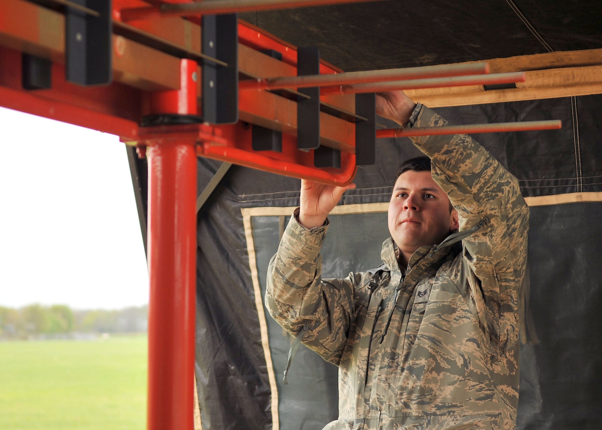 RAF MILDENHALL, England – Staff Sgt. Sergio Santos, 100th Communications Squadron, ensures there are no signal obstructions on a localizer antenna here May 4, 2012. The localizer antenna is half of the instrument landing system; the other half, located on the aircraft, receives signals put out by the antenna guiding the aircrew on to the flightline for a safe landing. (U.S. Air Force photo/Senior Airman Jerilyn Quintanilla)