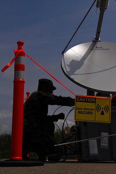 Tech. Sgt. David Defrank, a cyber-systems craftsman, attached to the 911th Airlift Wing Communications Squadron, works on the Joint Incident Site Communications Capability satellite dish (J.I.S.C.C.) outside of building 218, May 5, 2012. This system will be used by the 911th Communications Squadron during "Global Medic", a training exercise held at Fort Hunter-Ligget, CA, held in June 2012. (U.S. Air Force photo by Airman 1st Class Justyne Obeldobel/Released)