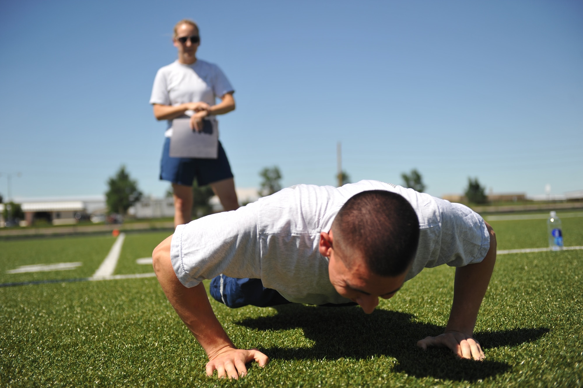 BUCKLEY AIR FORCE BASE, Colo. – Staff Sgt. Lauren Twigg, behind, Buckley AFB First Term Airman Center instructor, leads a group physical training session July 13, 2011. Buckley is playing its part in promoting May as National Fitness Month by having plenty of activities and classes planned throughout the month. (U.S. Air Force photo by Airman 1st Class Phillip Houk)