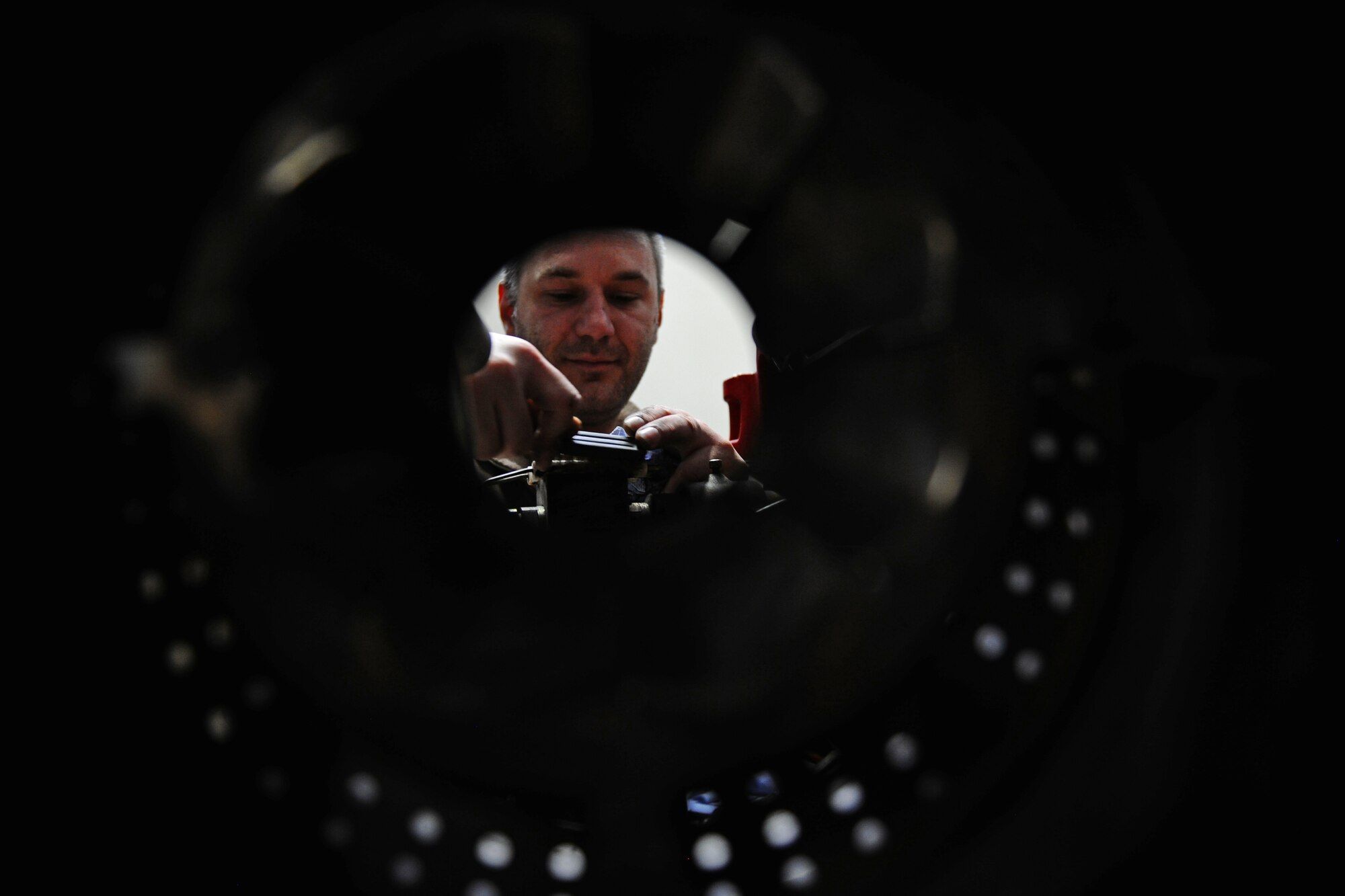SPANGDAHLEM AIR BASE, Germany – Hubert Berger, 52nd Civil Engineer Squadron Operations Flight Heating, Ventilation and Air Conditioning Element boiler mechanic, performs preventative maintenance on an oil burner by cleaning the nozzle and sparkplugs in Bldg. 34 here May 9. HVAC maintains, repairs and installs heating, cooling and ventilation systems located on Bitburg Annex, Spangdahlem AB and all of its geographically separated units. (U.S. Air Force photo by Airman 1st Class Matthew B. Fredericks/Released)