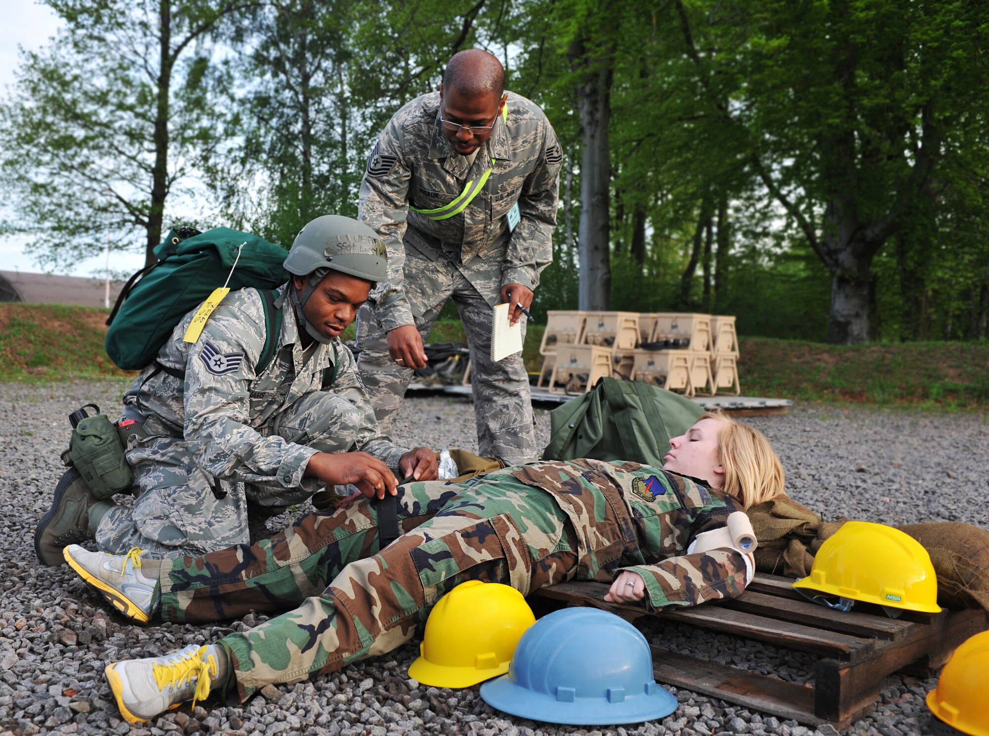 Staff Sgt. Larry Williams, 786th Force Support Squadron, provides self-aid
buddy care to a simulated injured victim while being observed by Tech. Sgt. Andrew Reaux, 2 Air Postal Squadron, during the operational readiness exercise scenario on Ramstein Air Base, Germany, May 10, 2012. The ORE incorporates a series of
scenarios used to evaluate a base's ability to execute operational duties
while responding to various crises. (U.S. Air Force photo/Senior Airman Caitlin
O'Neil-McKeown)

