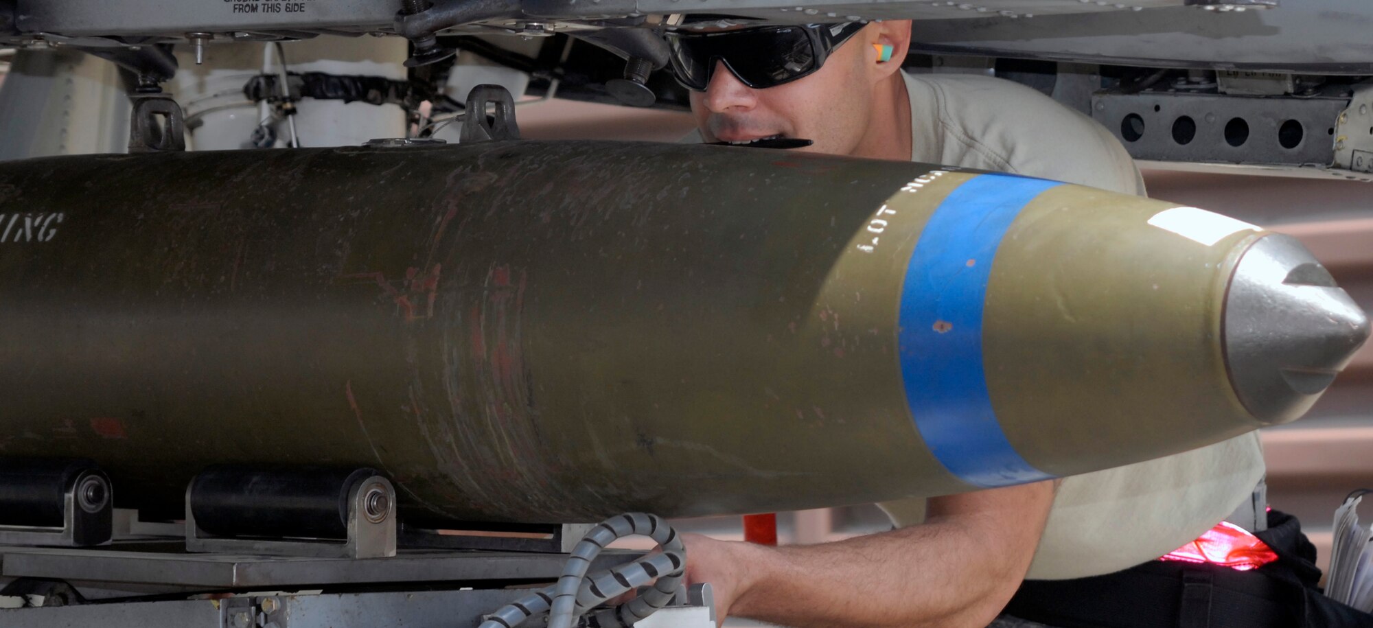 Tech. Sgt. Javier Figueroa-Chevere, 75th Aircraft Maintenance Unit weapons loader, loads a Mk-82 500-pound bomb on an A-10 during a weapon loading competition at Osan Air Base, Republic of Korea, May 5, 2012. (U.S. Air Force photo/Tech. Sgt. Eric Petosky)