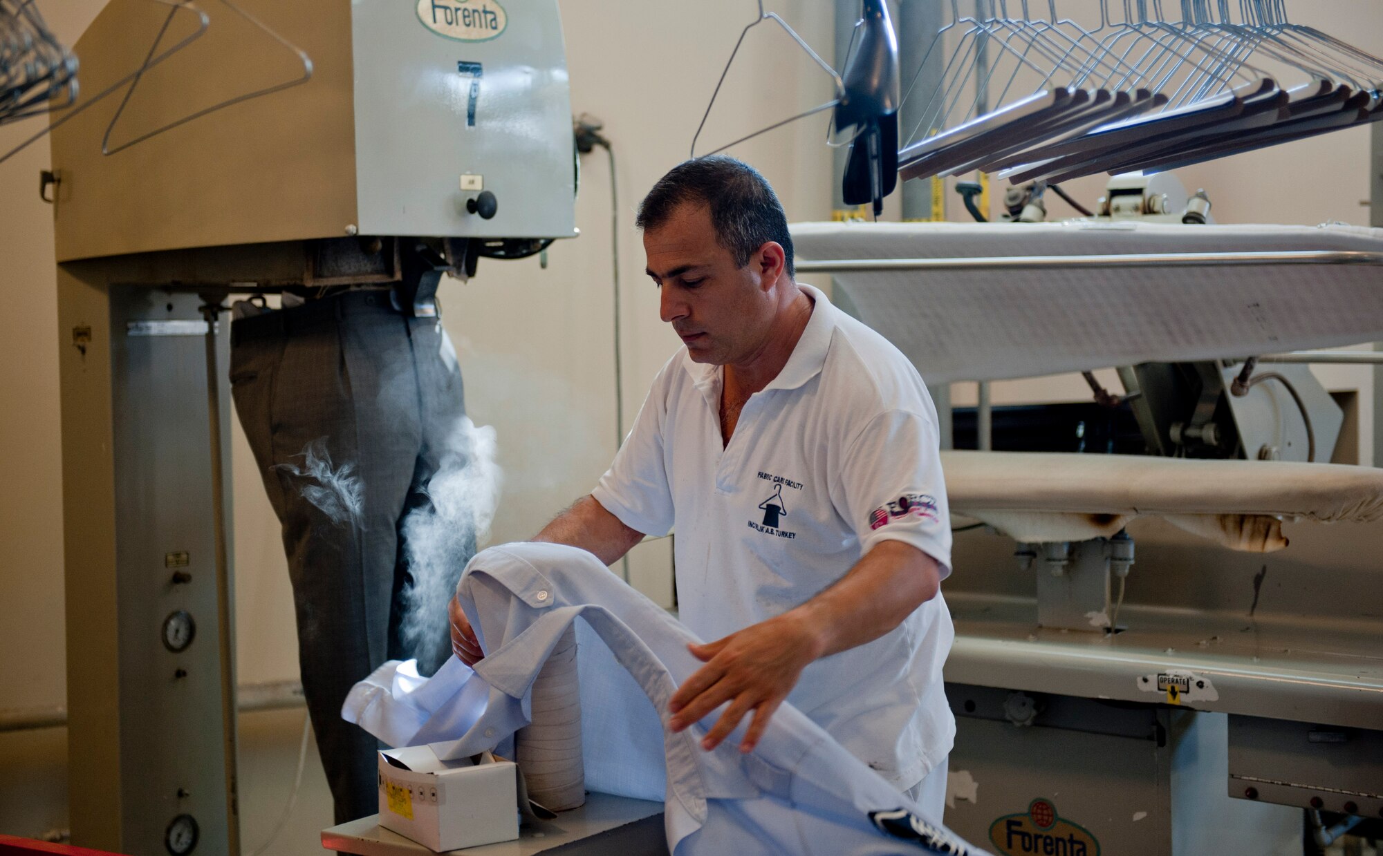 Levent Tokun, 39th Force Support Squadron dry cleaning technician, steam cleans a uniform May 9, 2012, at Incirlik Air Base, Turkey. Tokun works with approximately 15 other technicians at the facility, which is one of only two Air Force owned and operated fabric facilities in the Air Force. The other facility is located at Kadena Air Base, Japan. (U.S. Air Force photo by Senior Airman Anthony Sanchelli/Released)
