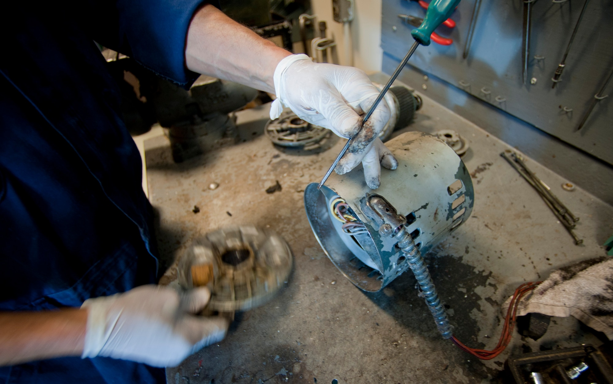 A member of the 39th Force Support Squadron repairs components of a machine from the fabric care facility May 9, 2012, at Incirlik Air Base, Turkey. The fabric care facility houses 125 machines, four of which were constructed by members of the facility. It is one of only two Air Force owned and operated fabric facilities in the Air Force. The other facility is located at Kadena Air Base, Japan. (U.S. Air Force photo by Senior Airman William O'Brien/Released)
