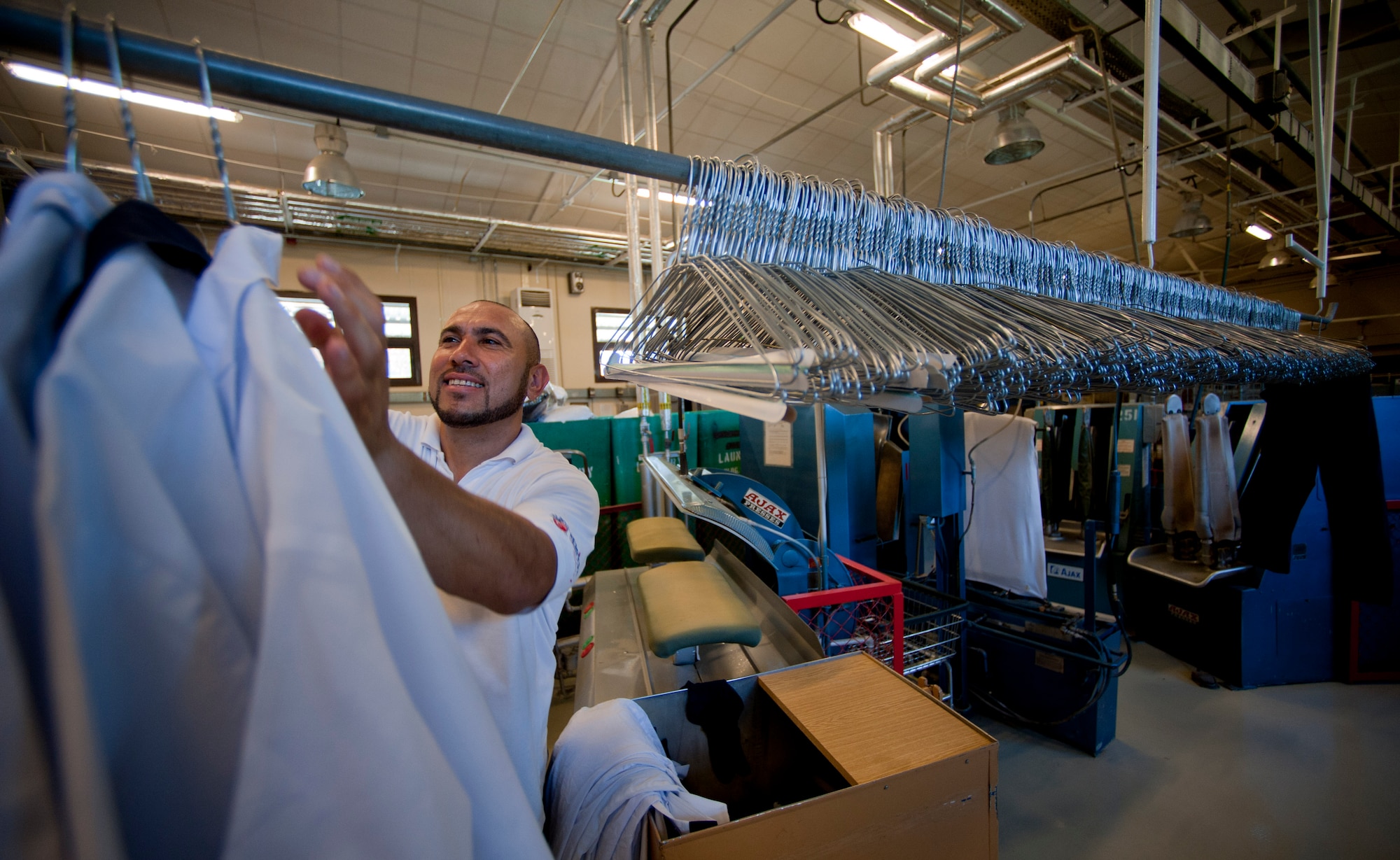 Ahmet Kocagay, 39th Force Support Squadron dry cleaning technician, hangs freshly pressed shirts on a rack May 9, 2012, at Incirlik Air Base, Turkey. Kocagay works with approximately 15 other technicians at the facility, which is one of only two Air Force owned and operated fabric facilities in the Air Force. The other facility is located at Kadena Air Base, Japan. (U.S. Air Force photo by Senior Airman William O'Brien/Released)
