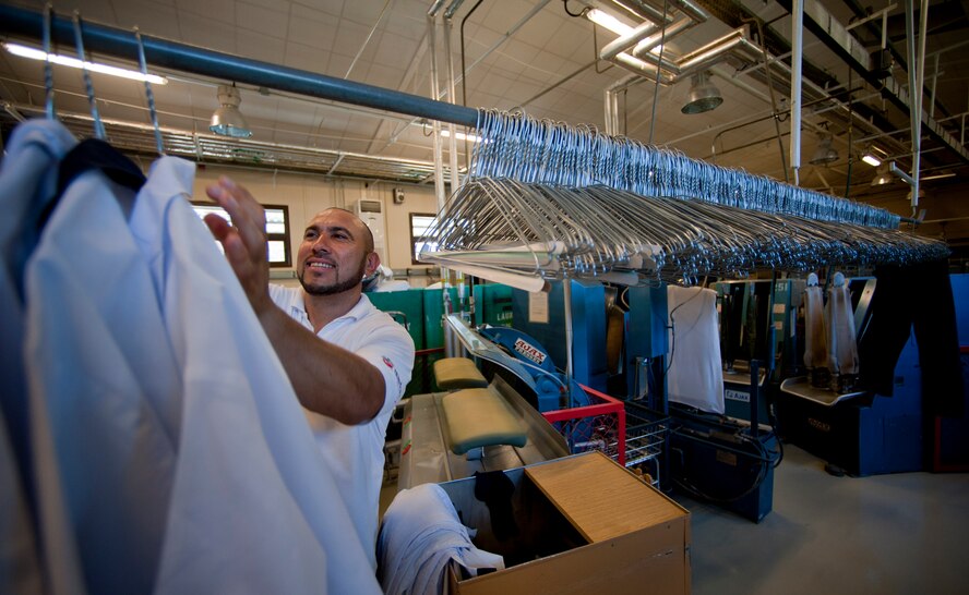 Ahmet Kocagay, 39th Force Support Squadron dry cleaning technician, hangs freshly pressed shirts on a rack May 9, 2012, at Incirlik Air Base, Turkey. Kocagay works with approximately 15 other technicians at the facility, which is one of only two Air Force owned and operated fabric facilities in the Air Force. The other facility is located at Kadena Air Base, Japan. (U.S. Air Force photo by Senior Airman William O'Brien/Released)
