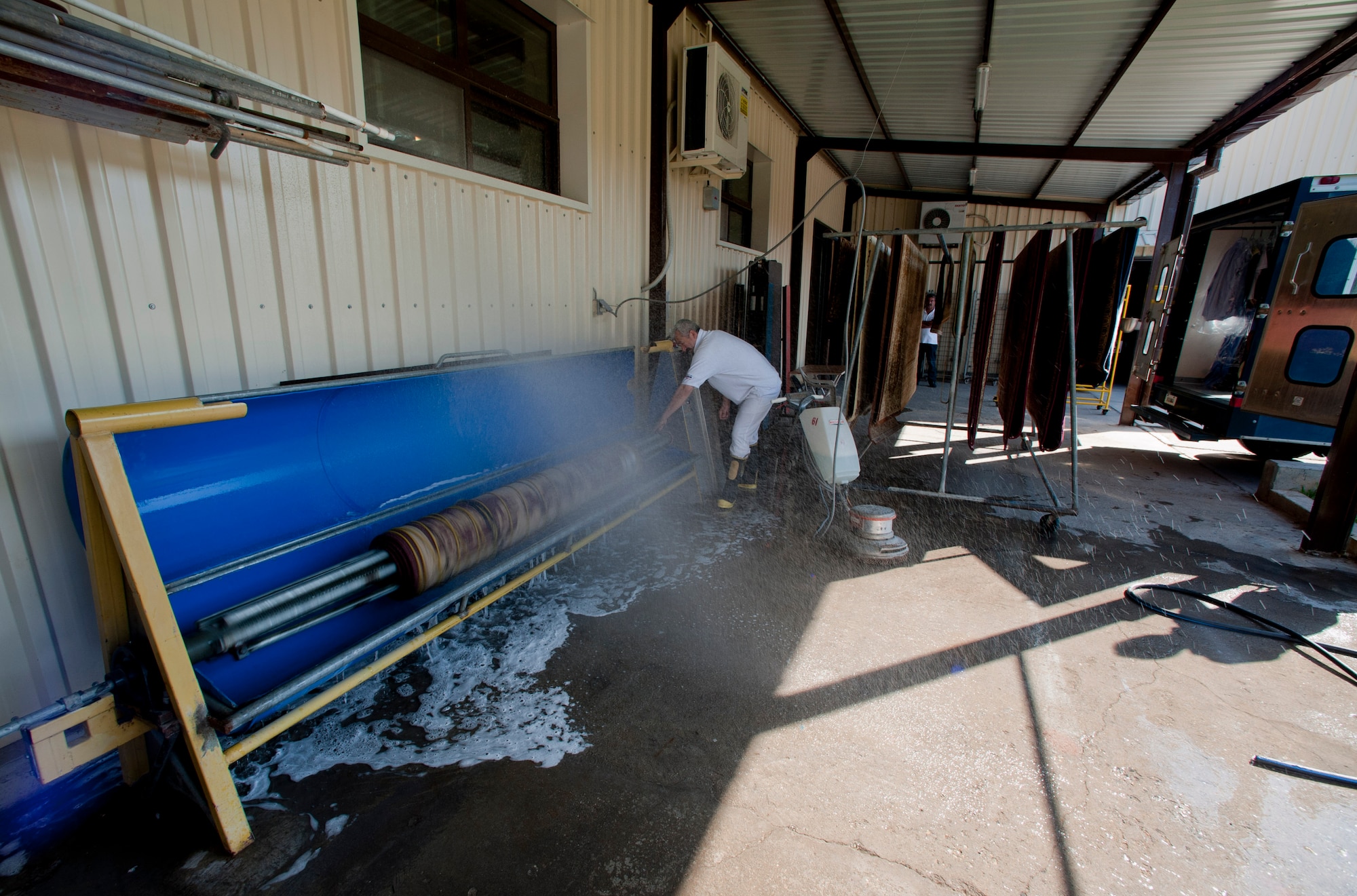 A member of the 39th Force Support Squadron washes a rug at the fabric care facility May 9, 2012, at Incirlik Air Base, Turkey. The fabric care facility is one of only two Air Force owned and operated fabric facilities in the Air Force. The other facility is located at Kadena Air Base, Japan. (U.S. Air Force photo by Senior Airman William O'Brien/Released)
