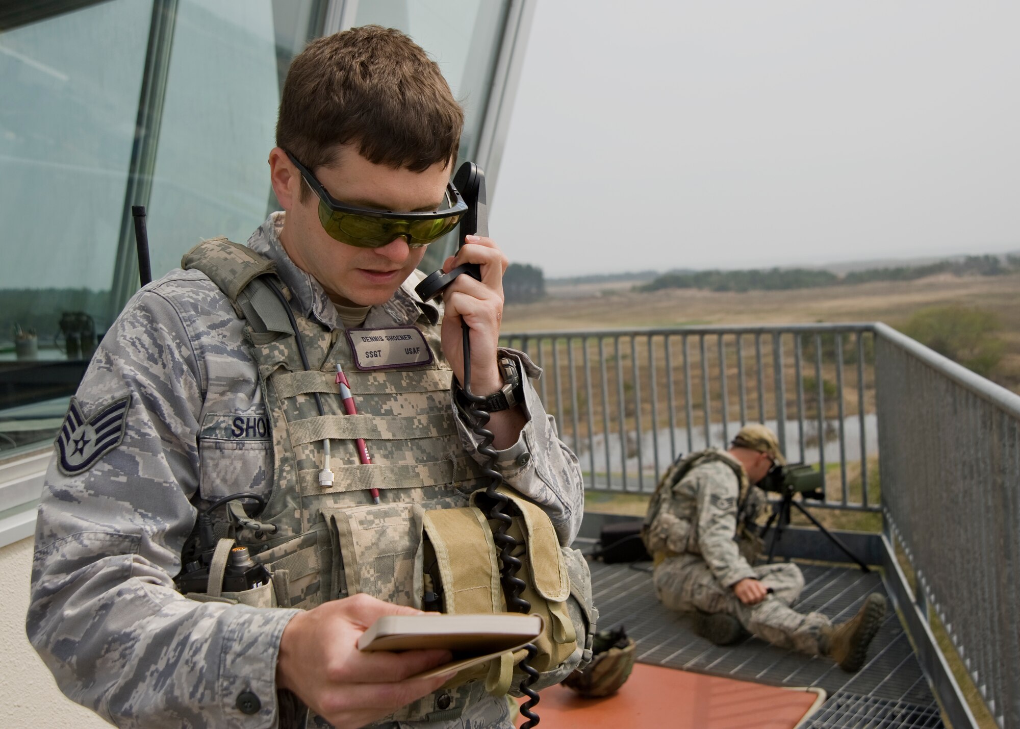 U.S. Air Force Staff Sgt. Dennis Shoener, 11th Air Support Operations Squadron joint terminal attack controller, calls in an air strike scenario while Staff Sgt. Weston Riley, 11 ASOS tactical air control party member, marks the target with a laser during the Diesel Weasel Exercise at Draughon Range, Japan, May 8, 2012. The JTACs created realistic scenarios for pilots from the 14th Fighter Squadron to react to and provided accurate air-to-ground targeting information. (U.S. Air Force photo by Staff Sgt. Nathan Lipscomb/Released)