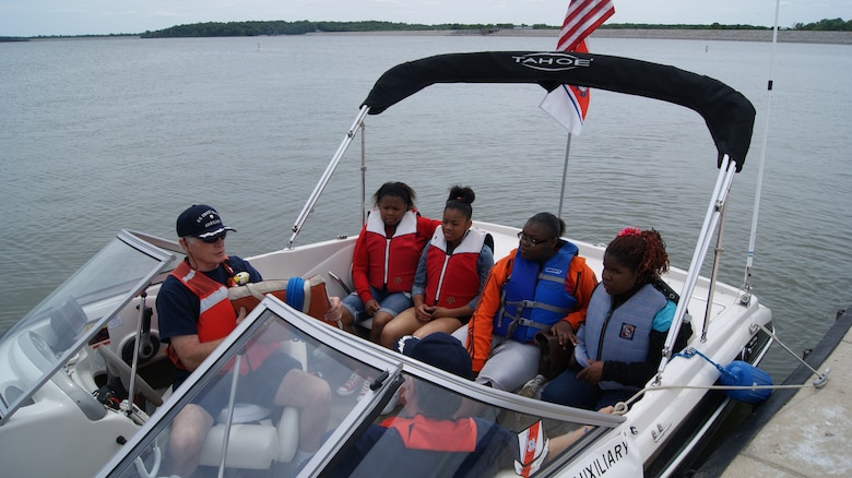 CARLYLE, Ill. — Members of U.S. Coast Guard Auxiliary discuss boating safety with students May 8 before taking them on a ride around Carlyle Lake.