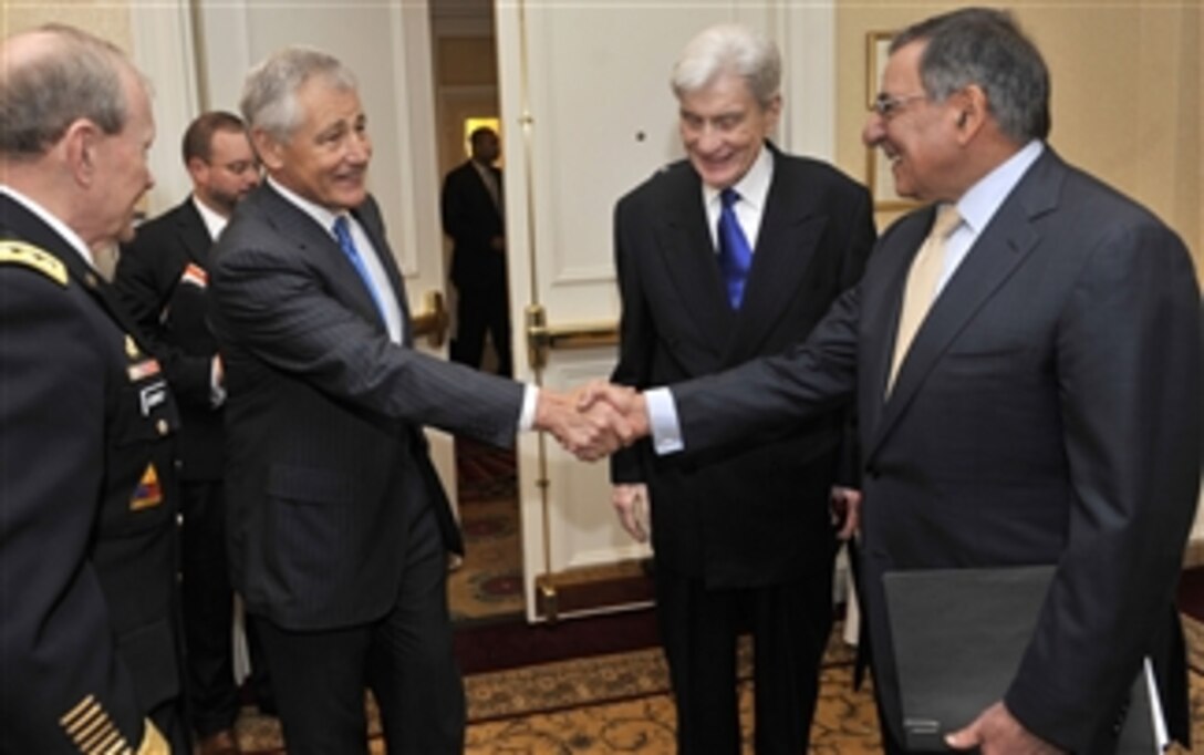 Former Sen. Chuck Hagel shakes hands with Secretary of Defense Leon E. Panetta shortly before Panetta and Chairman of the Joint Chiefs of Staff Gen. Martin E. Dempsey deliver remarks as the keynote speakers at the Forum on the Law of the Sea Convention held at the Willard Intercontinental Washington Hotel, Washington D.C, May 9, 2012.  Former Sen. John Warner joined in the welcoming for the two Defense officials.  