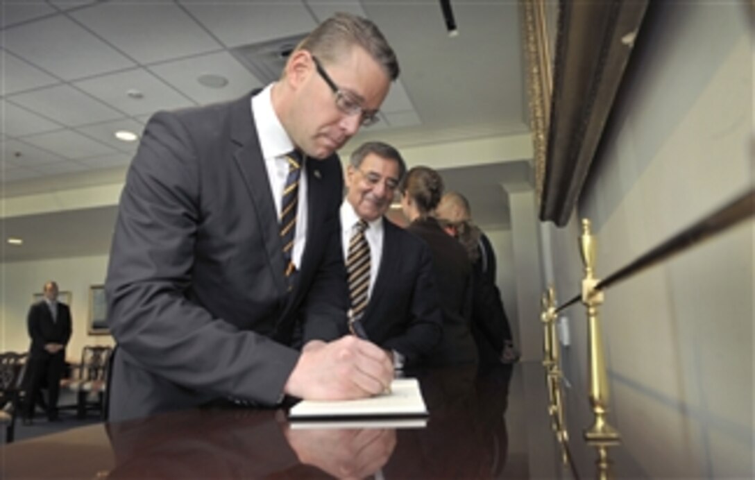 Finland's Minister of Defense Stefan Wallin signs the guestbook as Secretary of Defense Leon E. Panetta looks on as he arrives at the Pentagon in Arlington, Va., on May 10, 2012.  Panetta and Wallin will meet to discuss security issues of interest to both nations.  