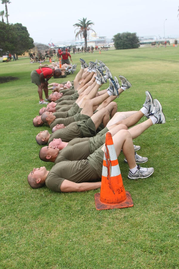 Company A recruits do various abdominal exercises before their two-mile run aboard Marine Corps Recruit Depot San Diego May 10. The company was broken down into groups and completed various exercises under the close supervision of a drill instructor.