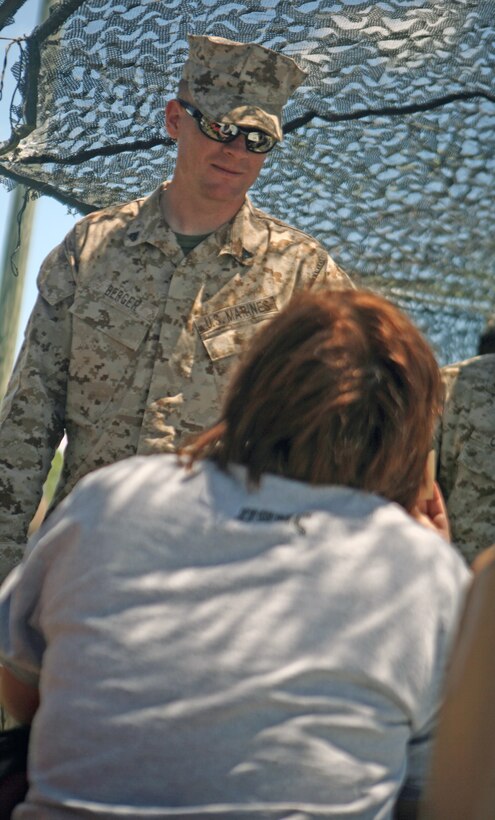 Corporal Phillip Berger (left), a rifleman with Headquarters Company, 2nd Marine Regiment, 2nd Marine Division, waits with his wife while range control clears a firing range during a Jane Wayne Day hosted by the company May 11.  The unit hosted the event to show the Marines wives how their husbands spend their day at work. (Official U.S. Marine Corps photo by Cpl. Clayton VonDerAhe)