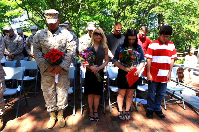 Master Sgt. Paul Vanek, a combat engineer with 8th Engineer Support Battalion, 2nd Marine Logistics Group, bows his head in prayer alongside his wife, Pam, and their two children, during his retirement ceremony at the Beirut Memorial site in Jacksonville, N.C., May 11, 2012.  Vanek was sincere in stating his appreciation for his family’s support throughout his 20-year career during his retirement speech.  (U.S. Marine Corps photo by Cpl. Katherine M. Solano)
