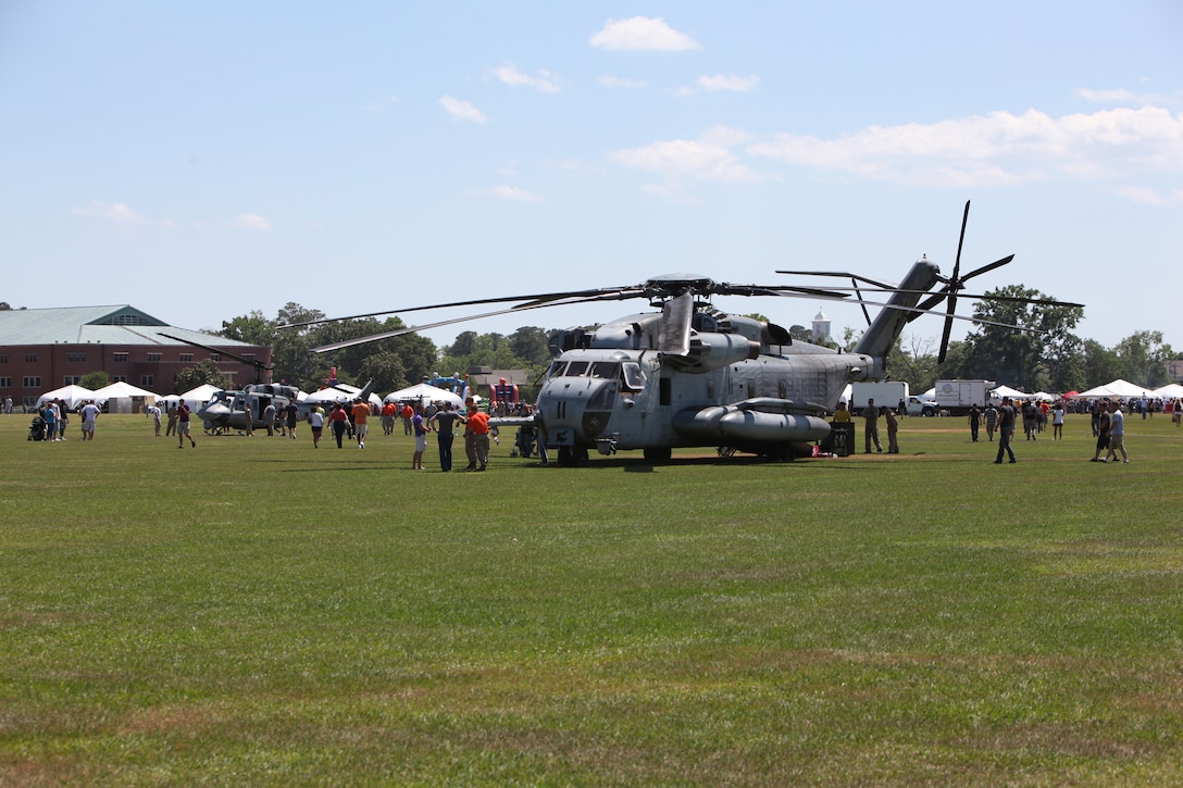 Marines with 2nd Marine Aircraft Wing show family members a CH-53E Super Stallion during the 2nd Marine Logistics Group family day aboard Camp Lejeune, N.C., May 11, 2012.  Family members also had the opportunity to see some of the Marine Corps’ trucks, tanks and heavy equipment as part of a static display at the event. The event was organized to commemorate the military spouse appreciation day.