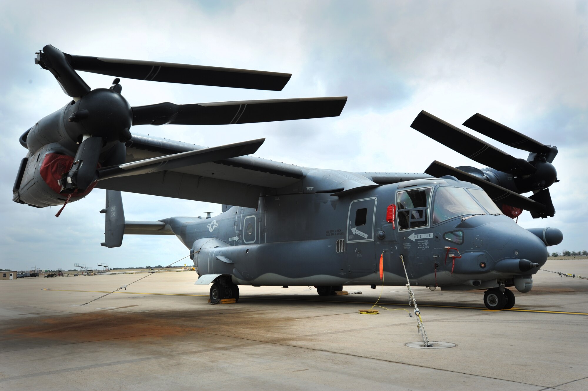 A CV-22 Osprey is chained to the flighline in preparation for a tornado exercise at Cannon Air Force Base, N.M., May 10, 2012.  The Osprey belongs to the 20th Special Operations Squadron – the “Green Hornets”.  (U.S. Air Force photo by Senior Airman Jette Carr)