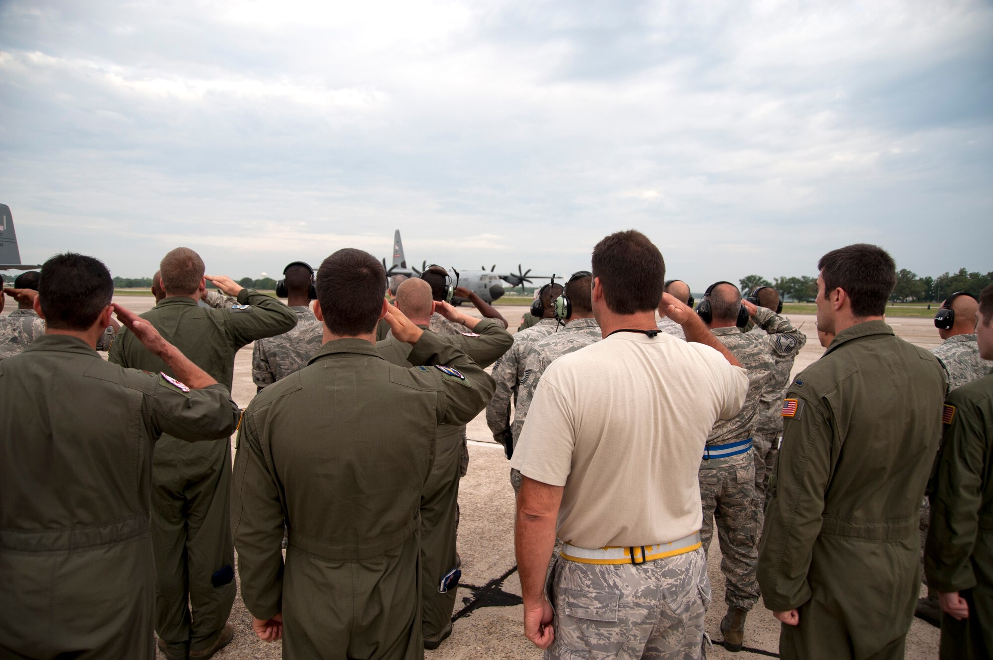 Members of the 403rd Wing render a final salute to the second of two aircraft headed to Southwest Asia in support of overseas contingency operations. The 345th Airlift Squadron "Golden Eagles" deployed May 9, one year ahead of schedule as they reached their full operation capability earlier than required. The 345th AS will be the lead squadron in the Total Force Integration effort with their Reserve squadron counterparts, the 815th AS "Flying Jennies." (U.S. Air Force photo by Maj. Heather Newcomb) 