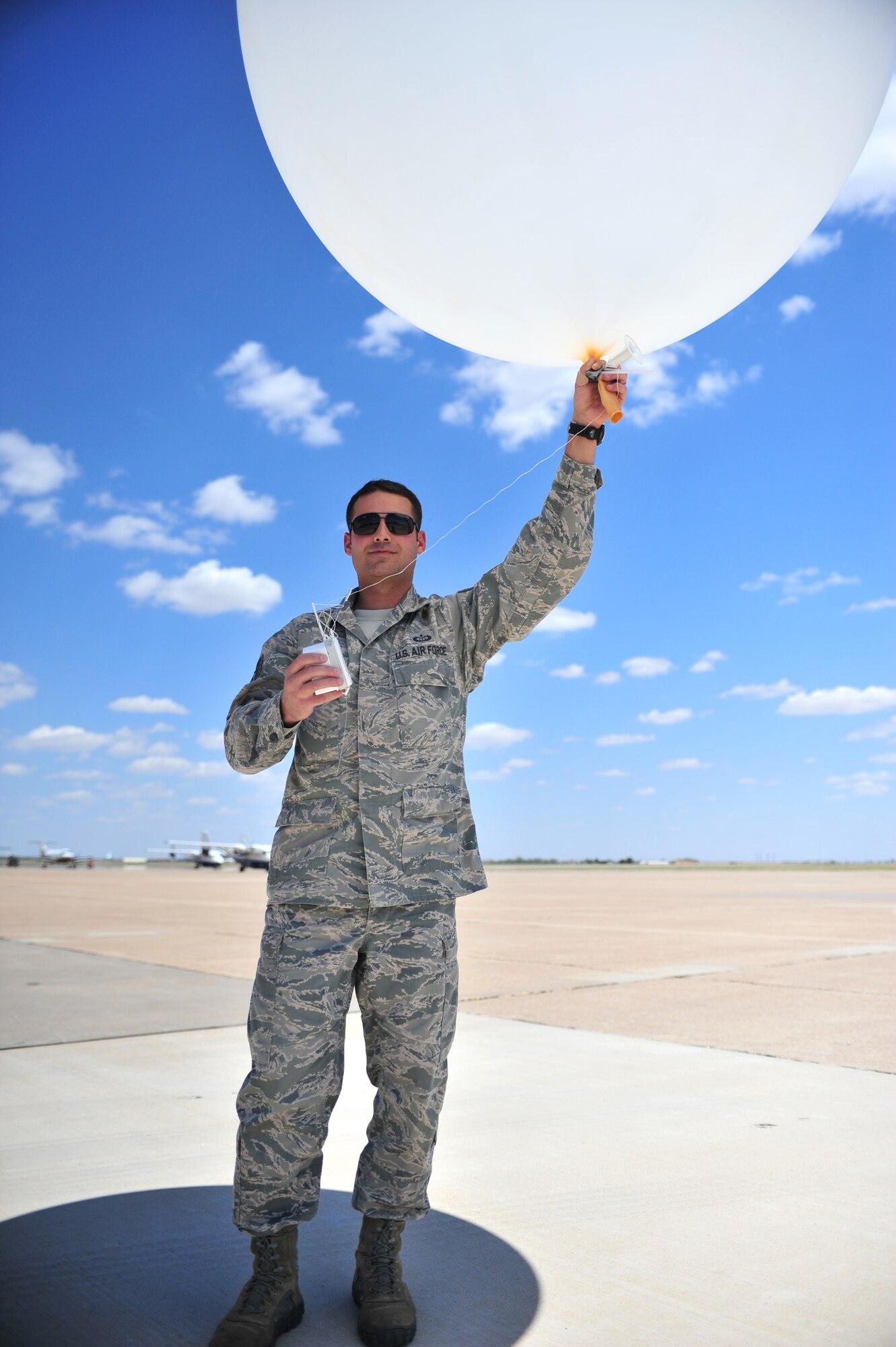 U.S. Air Force Staff Sgt. Phillip Tori, 27th Special Operations Support Squadron weather forecaster, stands on the flightline prepared to launch a weather balloon at Cannon Air Force Base, N.M., May 9, 2012. Troops with the weather flight at Cannon deal largely with resource protection and are able to track any weather systems that directly impact the base or personnel. (U.S. Air Force photo by Airman 1st Class Alexxis Pons Abascal)  