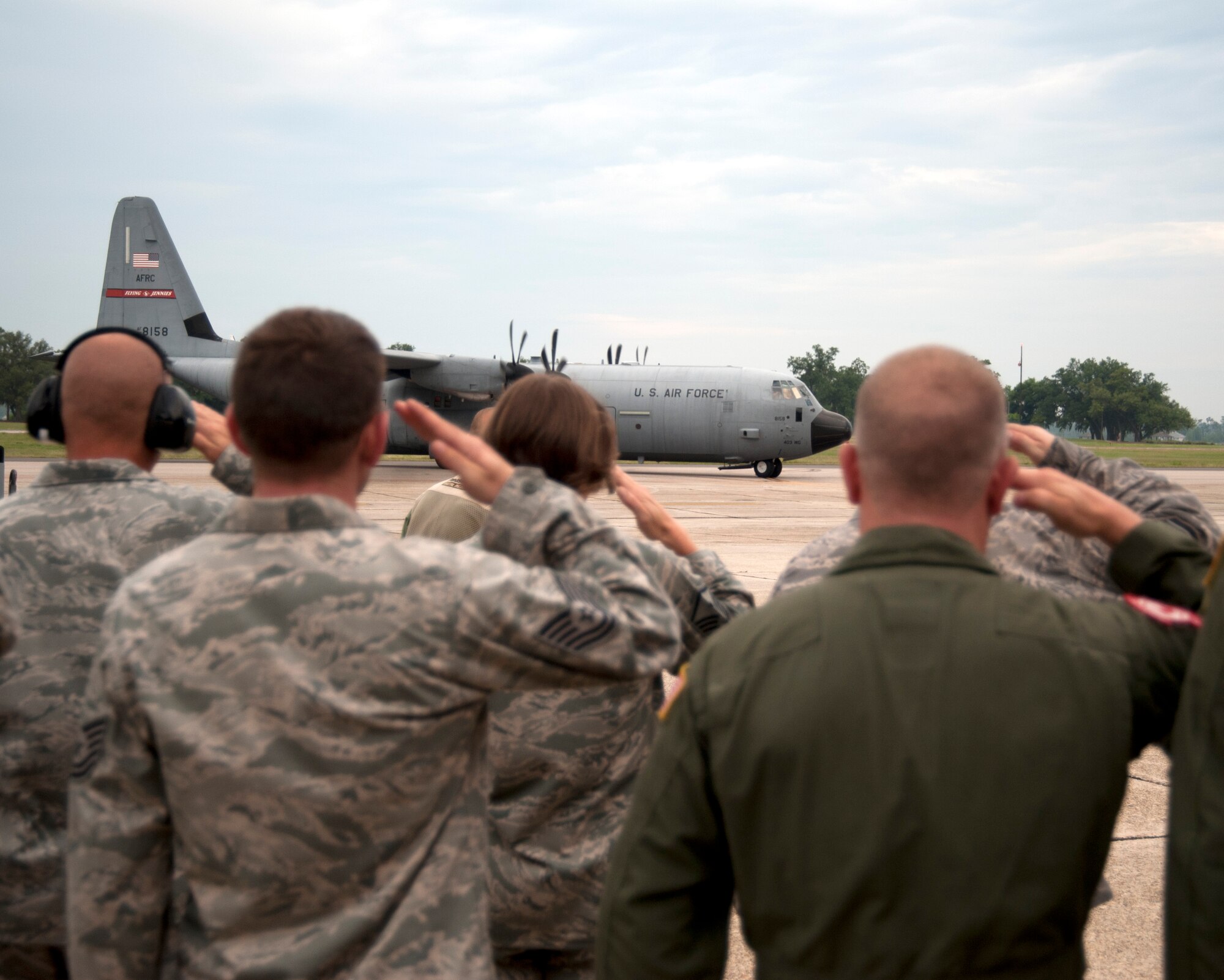 Members of the 403rd Wing render a final salute to the first of two aircraft headed to Southwest Asia in support of overseas contingency operations. The 345th Airlift Squadron "Golden Eagles" deployed May 9, one year ahead of schedule as they reached their full operation capability earlier than required. The 345th AS will be the lead squadron in the Total Force Integration effort with their Reserve squadron counterparts, the 815th AS "Flying Jennies." (U.S. Air Force photo by Maj. Heather Newcomb) 