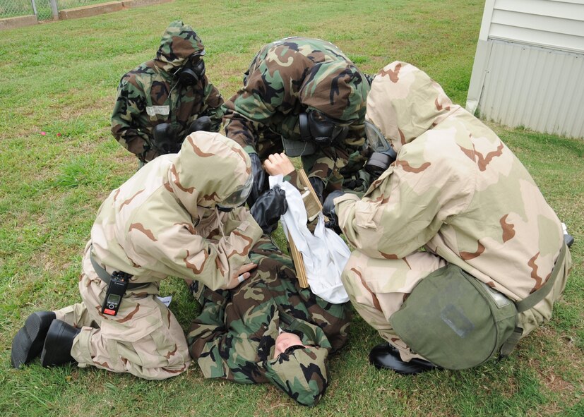 Barksdale Airmen conduct self-aid and buddy care on a simulated casualty during an Ability to Survive and Operate exercise on Barksdale Air Force Base, La., May 11. Airmen practiced basic life-saving steps include: establish an open airway, ensure breathing, stop bleeding, prevent further disability and minimize further exposure to adverse weather. (U.S. Air Force photo/Senior Airman Sean Martin)(RELEASED)
