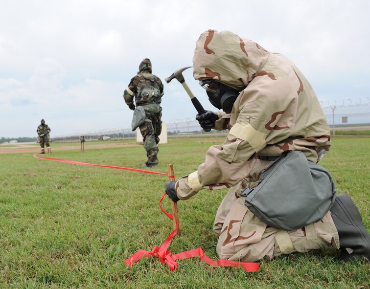 Barksdale Airmen cordon an area where a simulated unexploded ordnance was discovered during an Ability to Survive and Operate exercise on Barksdale Air Force Base, La., May 11. The markings were set up to alert others of a UXO in the area. (U.S. Air Force photo/Airman 1st Class Benjamin Gonsier)(RELEASED)  