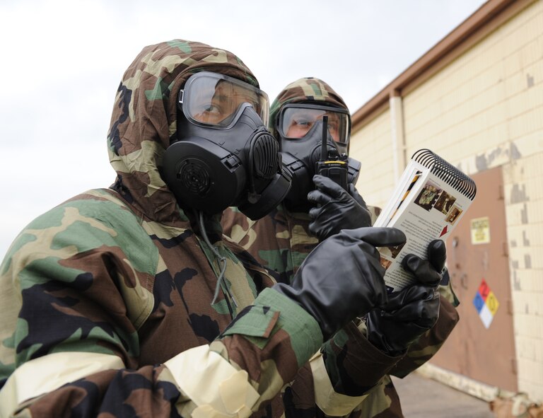 Barksdale Airmen watch a suspicious individual as they refer to the Airman's Manual during the Ability to Survive and Operate exercise on Barksdale Air Force Base, La., May 11. The ATSO exercise tested 2nd Bomb Wing Airmen on their ability to respond to various scenarios in a deployed environment. The Airman's Manual is a standard issue reference guide with information on a wide variety of Air Force subjects. (U.S. Air Force photo/Airman 1st Class Benjamin Gonsier)(RELEASED)
