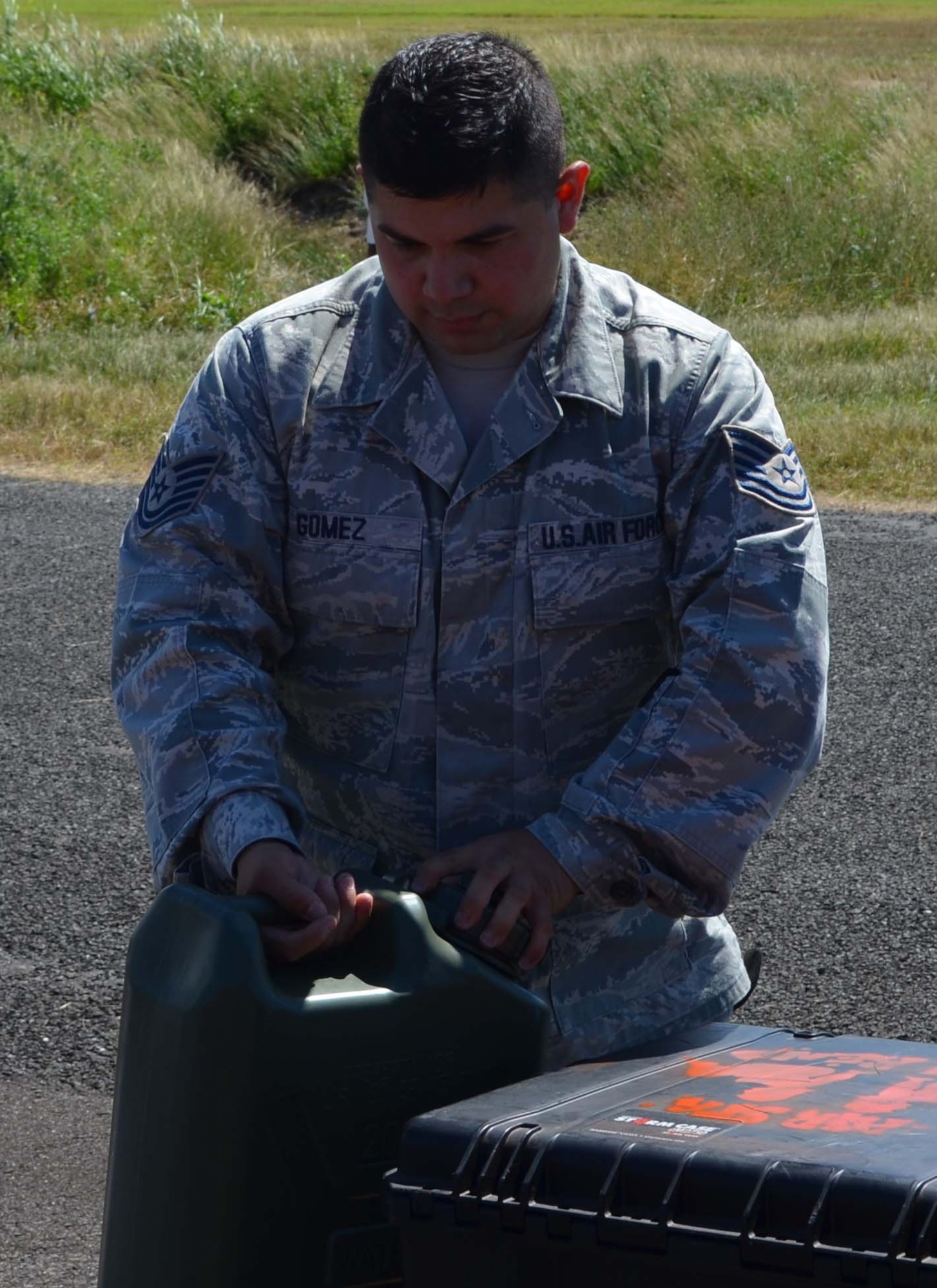 Tech. Sgt. Rudy Gomez, 74th Aerial Port Squadron, attempts to identify the contents of a container during a joint inpsection of U.S. Coast Guard equipment in Cairns, Australia on May 6, 2012. All materials must be inspected and properly identified and labeled befoer boarding an aircraft. (U.S.Air Force Photo/Maj. Tim Wade)
