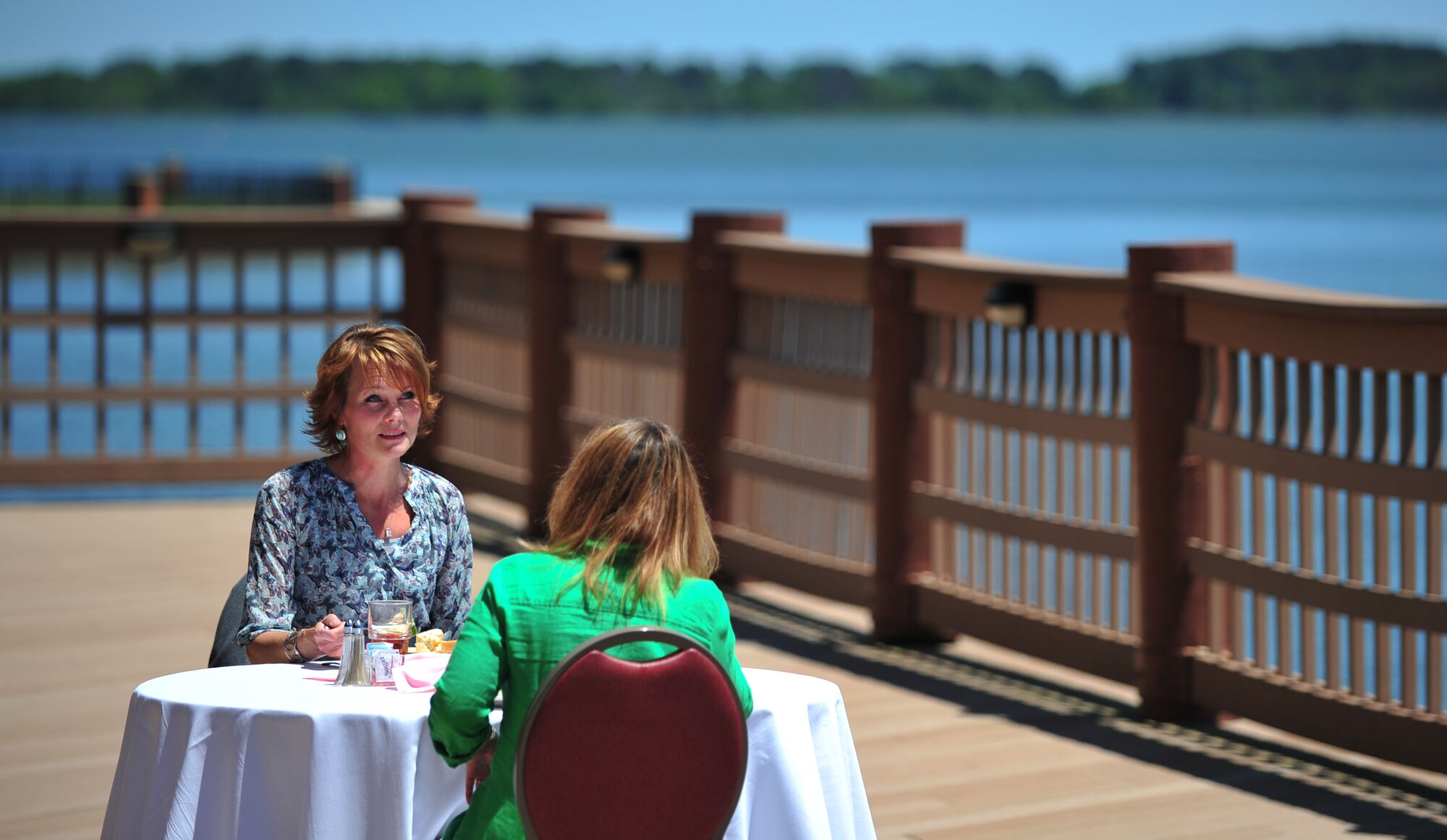 Kristin Auch listens to Cassie Bends, wife of Staff Sgt. Bradford Bends II, 633rd Civil Engineer Squadron explosive ordnance disposal technician, during a lunch at the Langley Club, Langley Air Force Base, Va., May 11, 2012. Auch, wife of Col. Korvin Auch, 633rd Air Base Wing commander, said being a military spouse may be tough at times, but always worthwhile. (U.S. Air Force photo by Senior Airman Jarad A. Denton) 