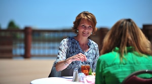 Kristin Auch, wife of Col. Korvin Auch, 633rd Air Base Wing commander, listens to Cassie Bends, wife of Staff Sgt. Bradford Bends II, 633rd Civil Engineer Squadron explosive ordnance disposal technician, during a lunch at the Langley Club, Langley Air Force Base, Va., May 11, 2012. The lunch was held on Spouse Appreciation Day, a day set aside to honor the roles held and sacrifices made by military spouses. (U.S. Air Force photo by Senior Airman Jarad A. Denton) 