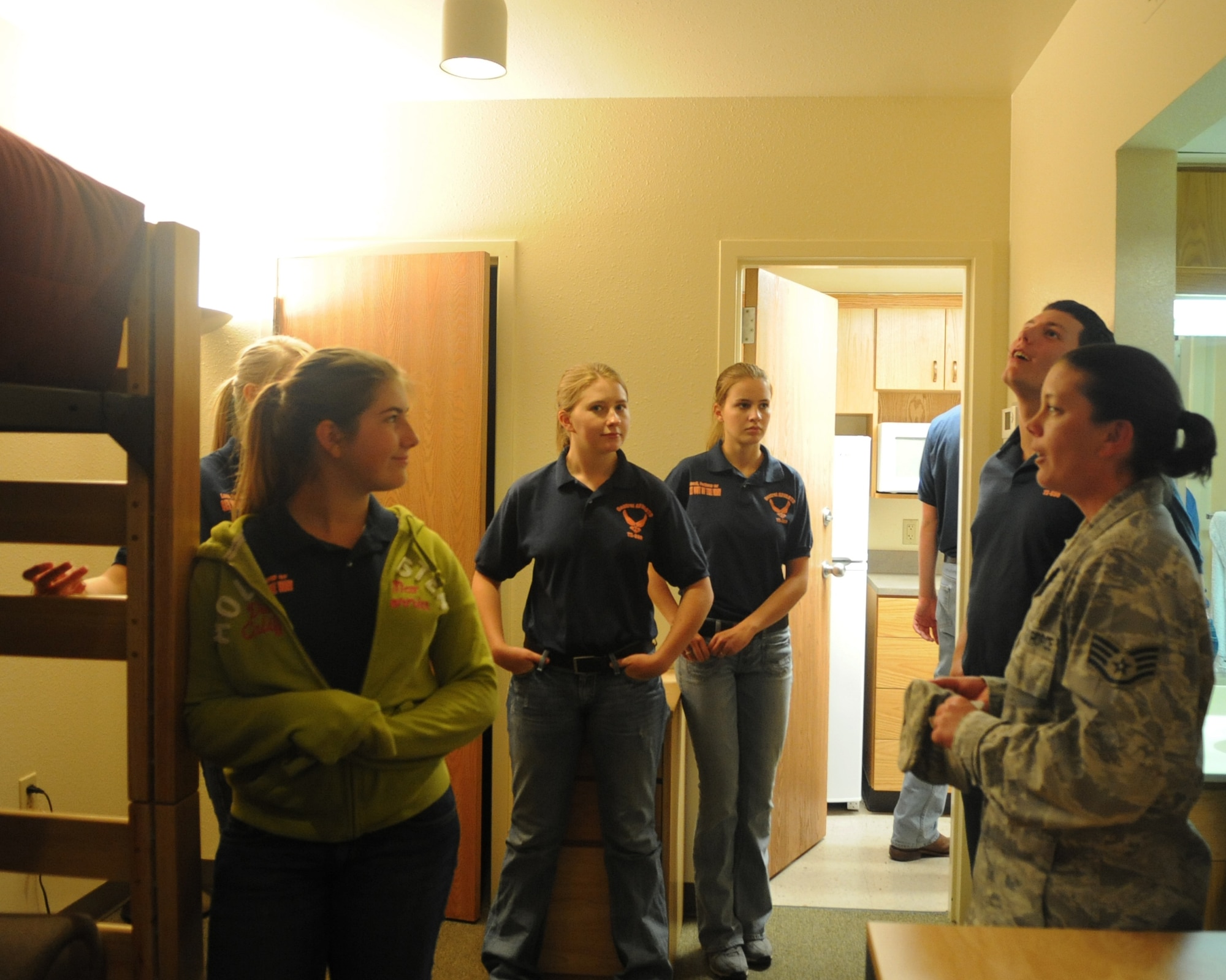 U.S. Air Force Staff Sgt. Kelly Lee, 7th Civil Engineer Squadron, right, shows JROTC students from Central High School, San Angelo, Texas, airman dorms, May 9, 2012, at Dyess Air Force Base, Texas. The students toured different parts of Dyess including the airpark, dorms, hush house and the military working dogs kennel. (U.S. Air Force photo by Airman 1st Class Cierra bullock/Released)
