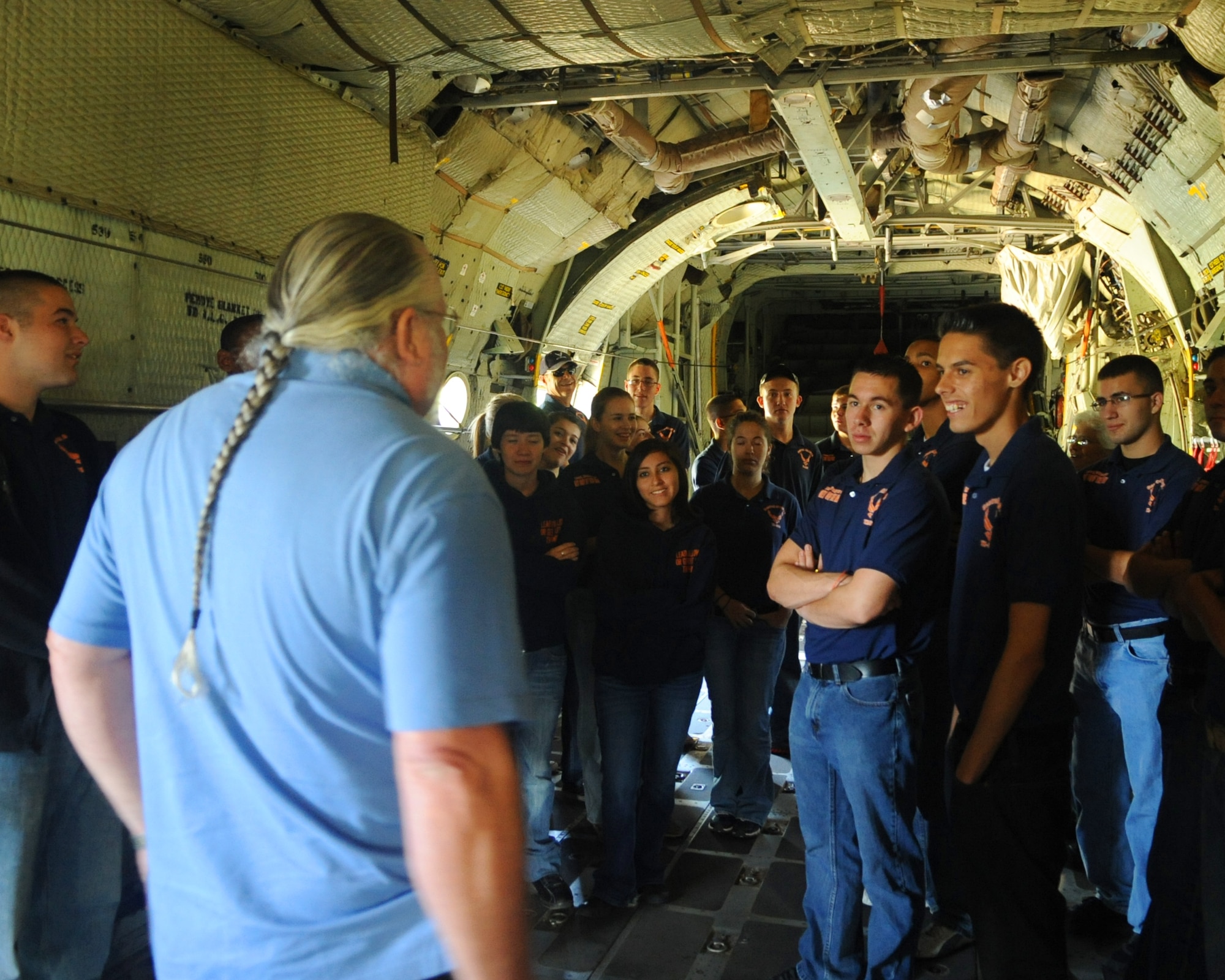JROTC students from Central High School, San Angelo, Texas, listen to retired Master Sgt. Richard Warner, base historian, talk about the C-130A model, which the students are standing in, May 9, 2012, at Dyess Air Force Base, Texas. The aircraft was the first C-130 delivered to the Air Force Dec. 1956 to the 463d Troop Carrier Wing at Ardmore AFB, Oklahoma. (U.S. Air Force photo by Airman 1st Class Cierra Bullock/ Released) 