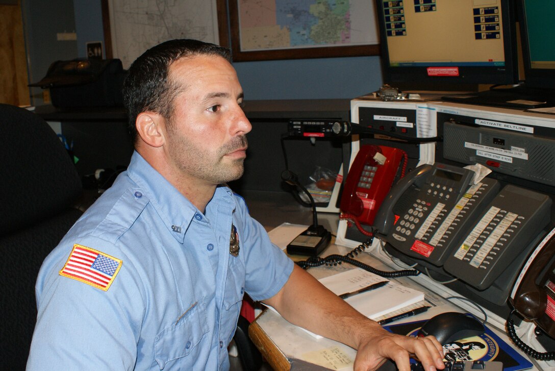 Jason Dandurand, emergency dispatcher with the Sheppard Air Force Base Fire Department, checks the computer for information during a fire alarm call in the base emergency communications control center May 11, 2012.  Dandurand's handling of an emergency 9-1-1 call helped save a three-year old child during a near-drowing incident. (U.S. Air Force photo/Dan Hawkins)