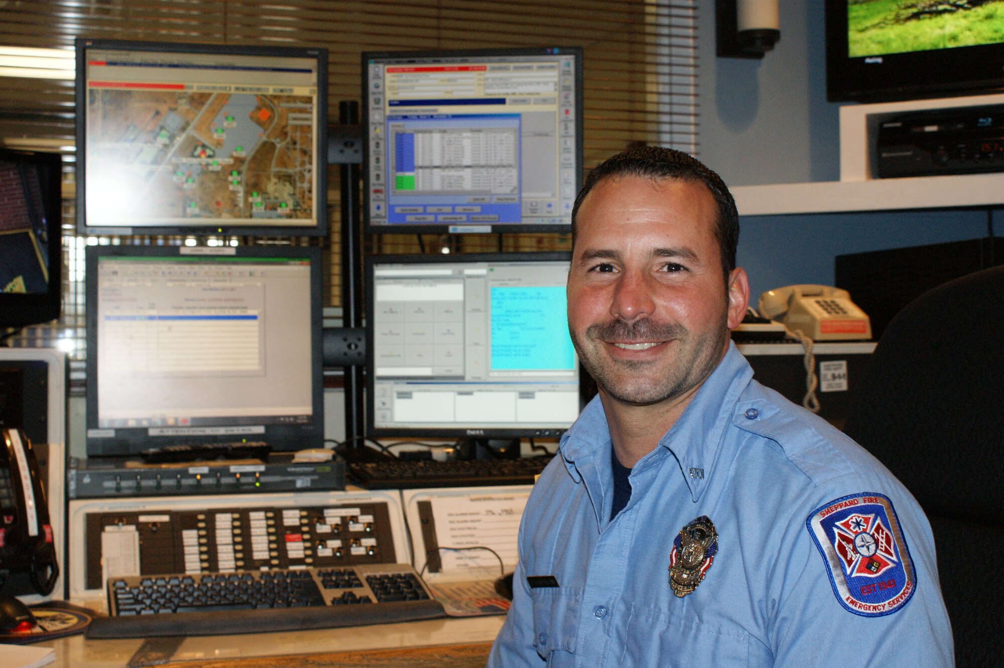 Jason Dandurand, emergency dispatcher with the Sheppard Air Force Base Fire Department,at work in the emergency communications control center May 11, 2012.  Dandurand's handling of an emergency 9-1-1 call helped save a three-year old child during a near-drowing incident. (U.S. Air Force photo/Dan Hawkins)