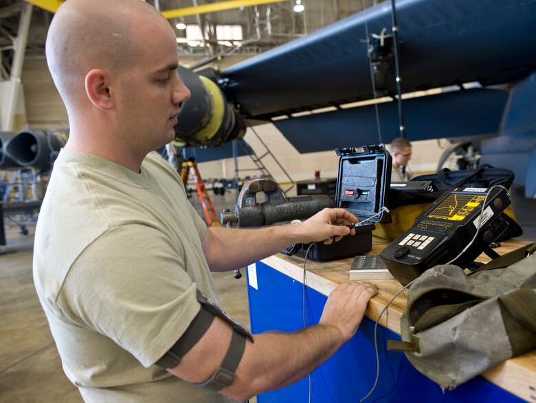 Senior Airman Paul Nessle, 2nd Maintenance Squadron non-destructive inspector, calibrates an eddy current machine before conducting a test on Barksdale Air Force Base, La., May 9. The portable machine is used to check for cracks of aircraft components without removing them from the aircraft. (U.S. Air Force photo/Staff Sgt. Chad Warren)(RELEASED)