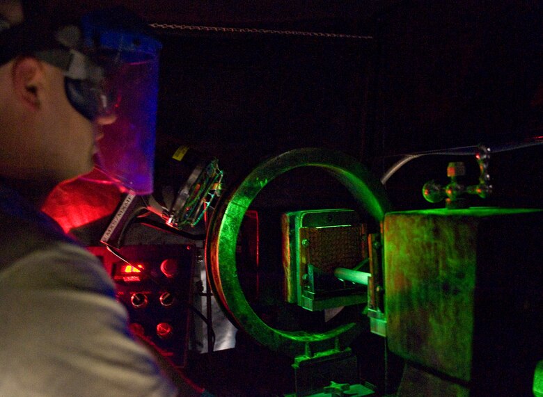 Senior Airman Paul Nessle, 2nd Maintenance Squadron non-destructive inspector, checks for cracks on an aircraft part during a fluorescent magnetic particle test on Barksdale Air Force Base, La., May 9. This is one of many tests NDI Airmen use to ensure the structural integrity of aircraft components. (U.S. Air Force photo/Staff Sgt. Chad Warren)(RELEASED)