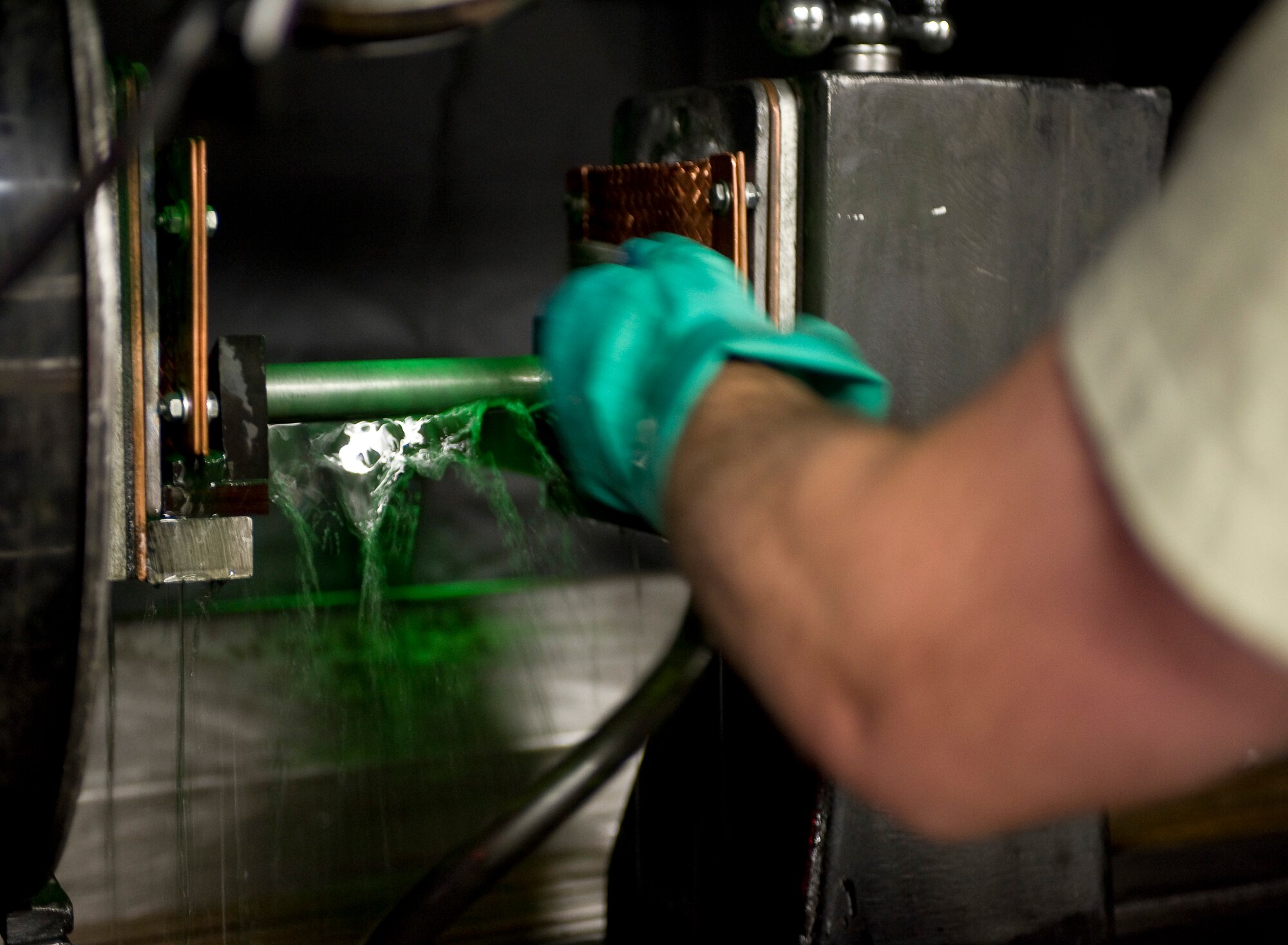 Senior Airman Paul Nessle, 2nd Maintenance Squadron non-destructive inspector, applies a fluorescent magnetic particle solution to an aircraft part on Barksdale Air Force Base, La., May 9. When magnetized, the solution will show the NDI Airmen if there are any cracks in the part. (U.S. Air Force photo/Staff Sgt. Chad Warren)(RELEASED)