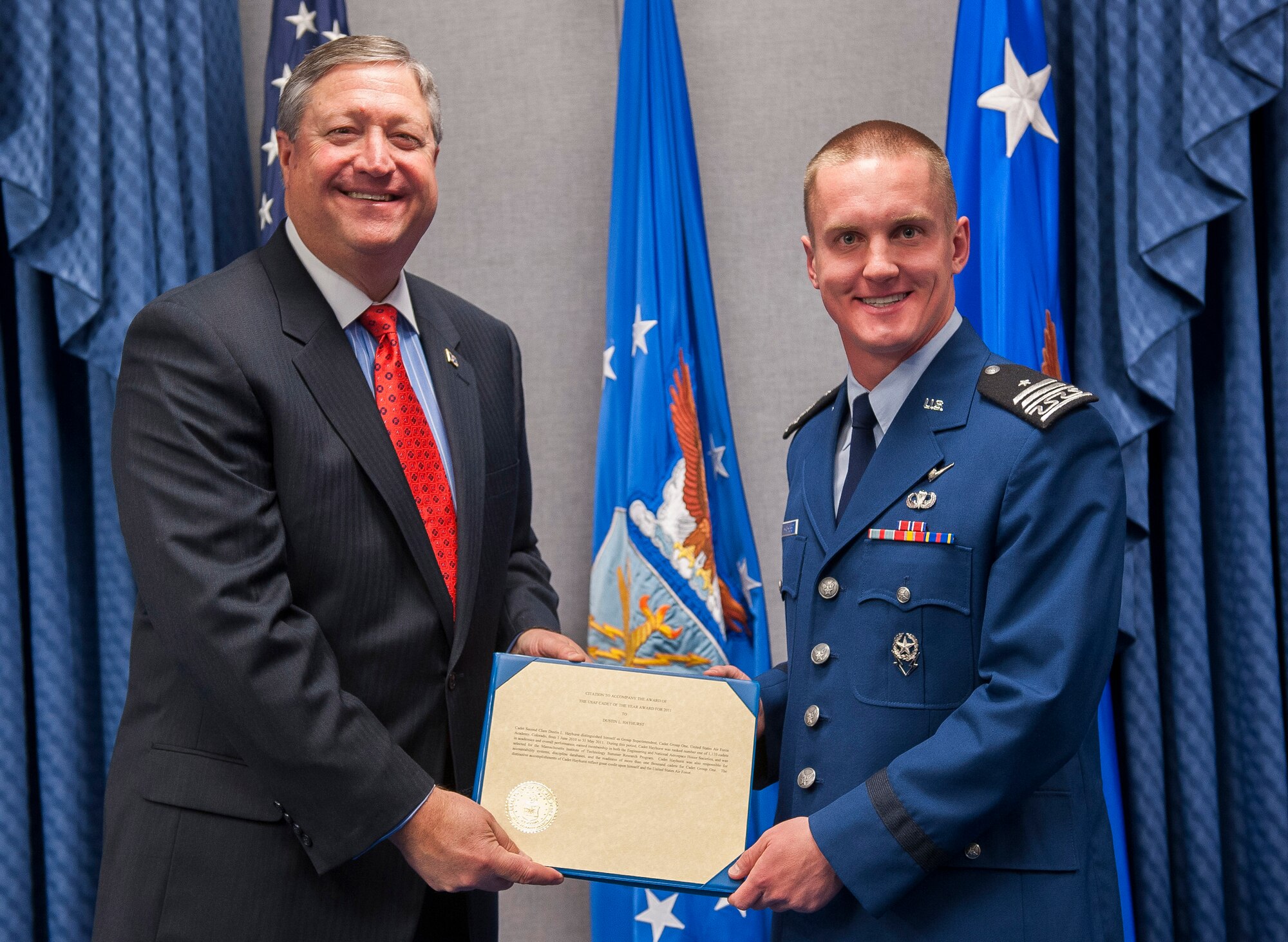Secretary of the Air Force Michael Donley (left) presents the 2011 U.S. Air Force Cadet of the Year Award to Air Force Academy Cadet 1st Class Dustin Hayhurst May 10, 2012, during a ceremony  in the Pentagon in Washington, D.C. Cadet Hayhurst earned the award by demonstrating excellence in military skills, academics and athletics in an Air Force commissioning program  (U.S. Air Force photo/Jim Varhegyi)